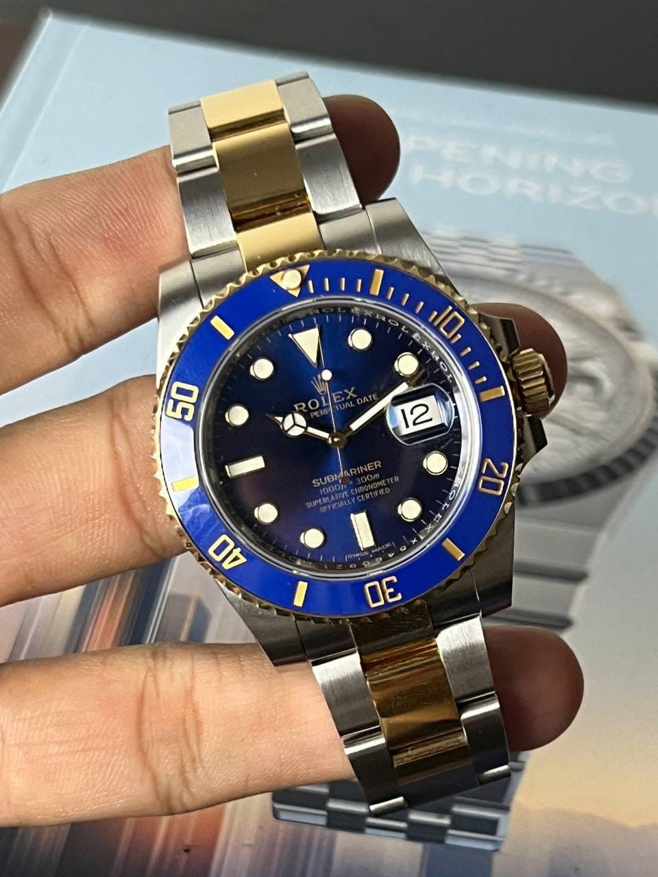 May be an image of wrist watch and text that says '3 10 A A 50 12 SUBM UBMARINER RINER S 6 20 40 + ك 1 30'