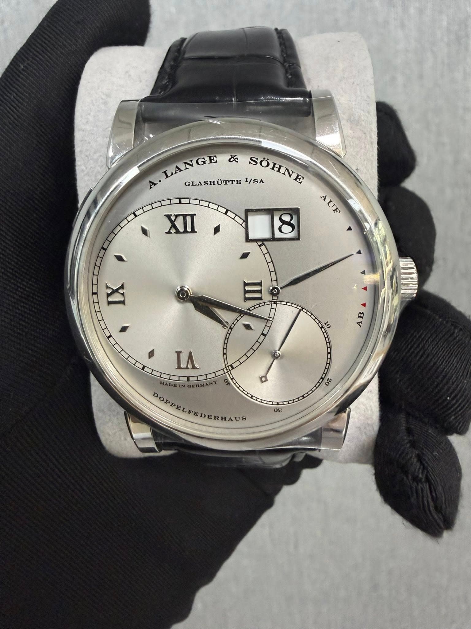 May be an image of wrist watch and text that says '& A LANGE LAN GLASHUTTE SÖHNE /SA AUF XII 8 IX 10 후 AB 6 ΙΛ D 8 DOPPELPEDERHAUS ERIAUS 00 DE UE'