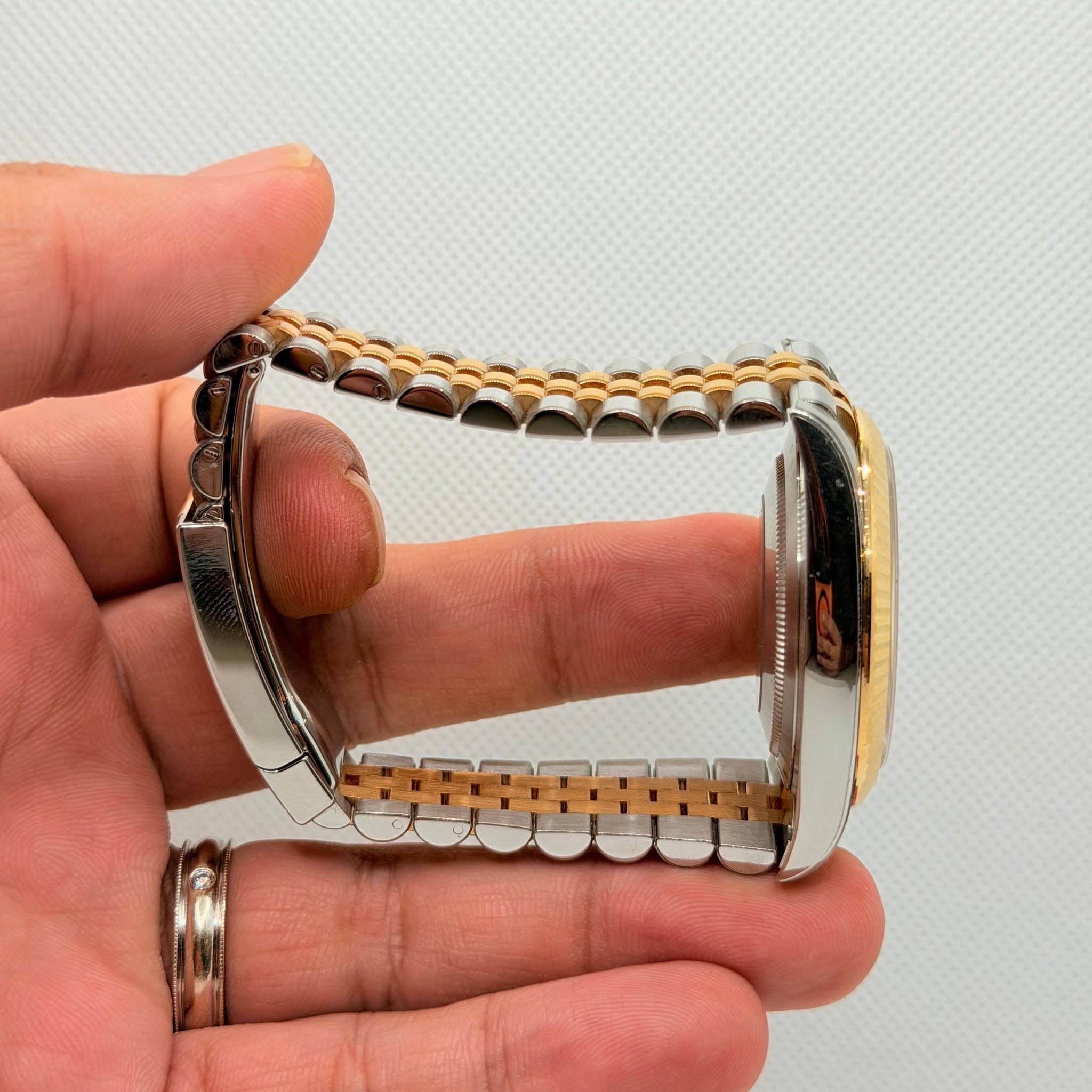 May be an image of wrist watch and jewelry