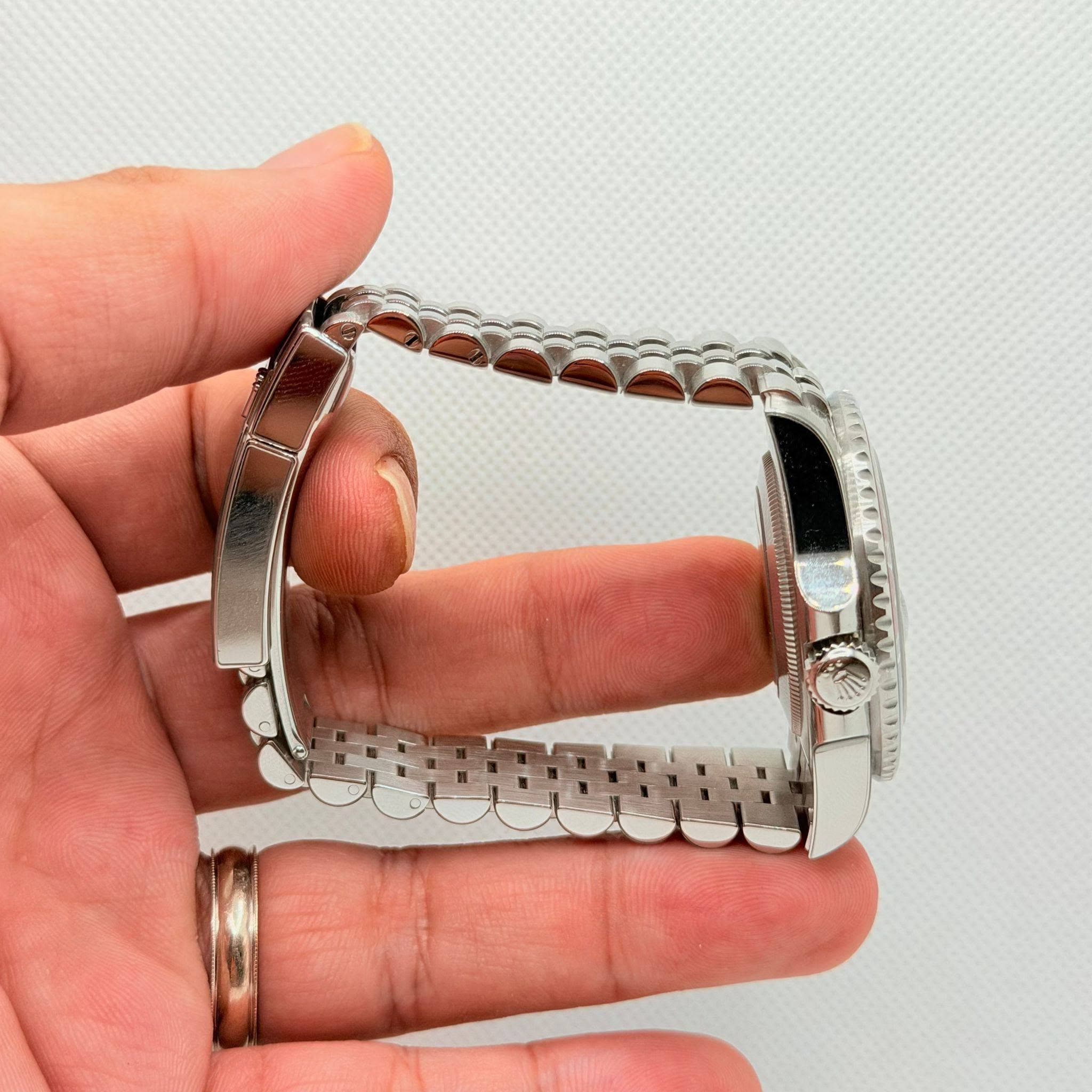 May be an image of wrist watch and jewelry