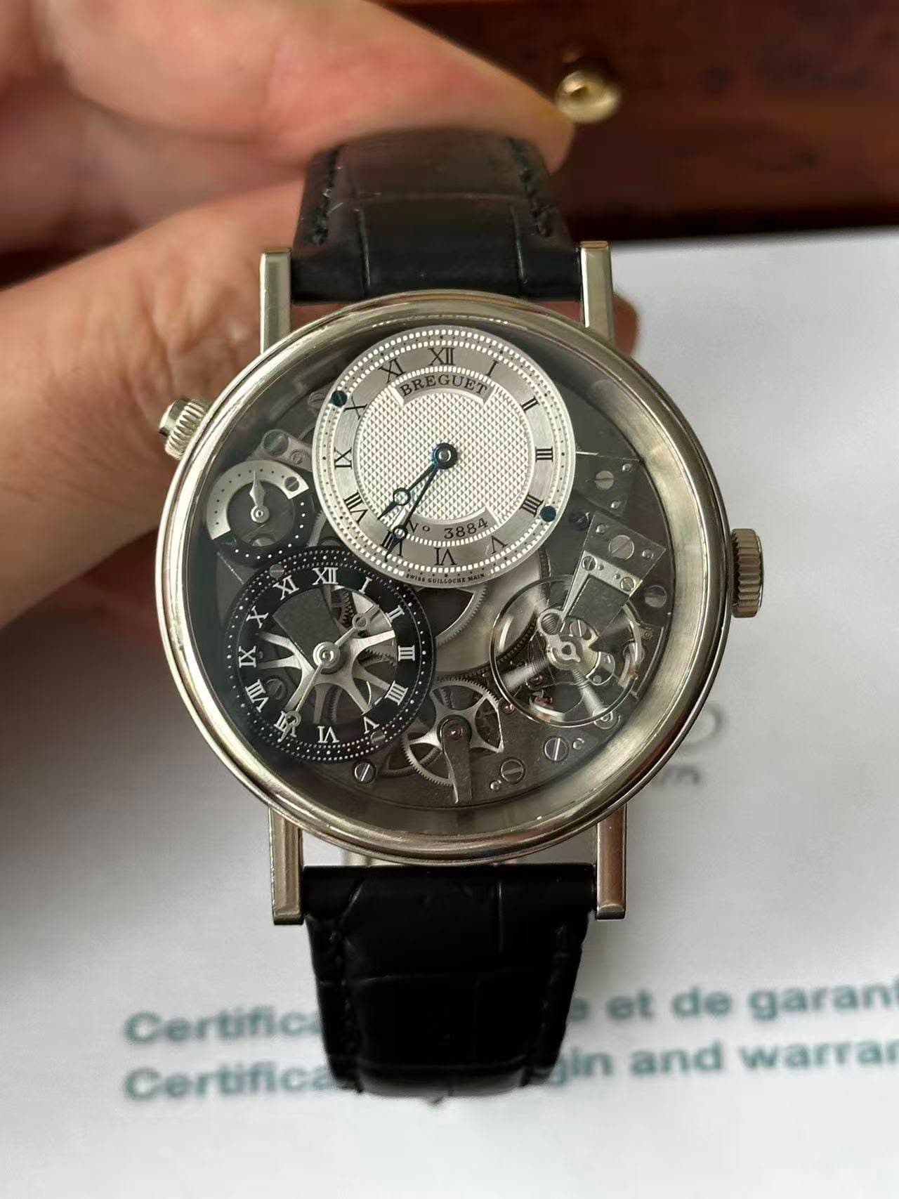 May be an image of wrist watch and text that says 'mram SMI II O 4 VIII III 6 XI XII PO ه III IX VIII I M IA 自 Certifica Certifica et de garan gin and warra'