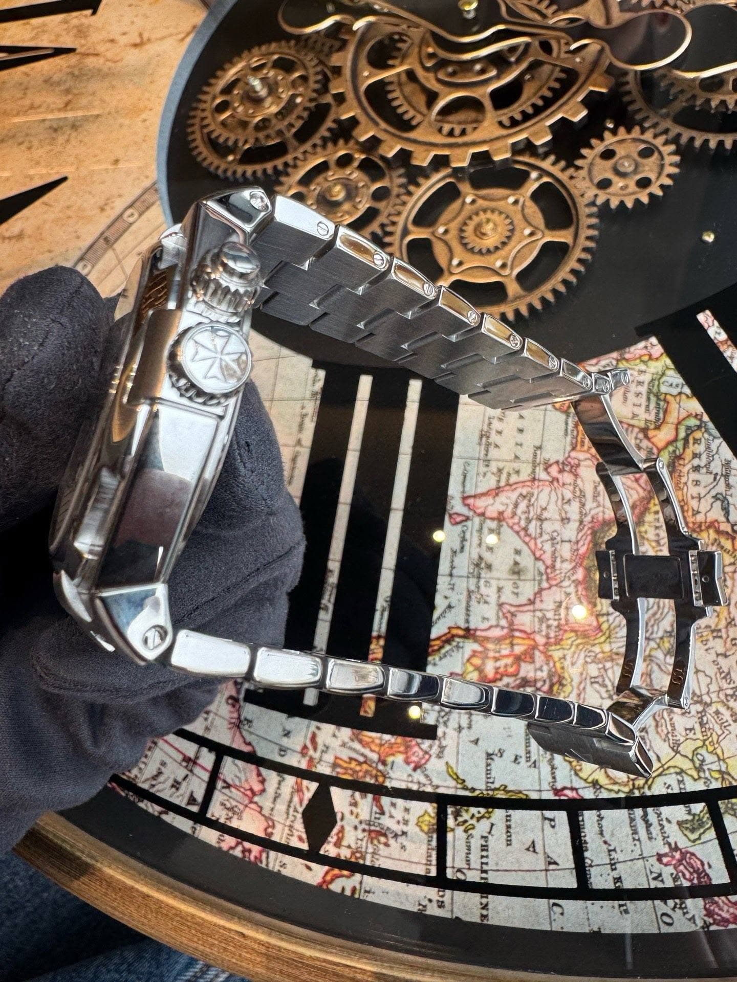 May be an image of wrist watch, map and text