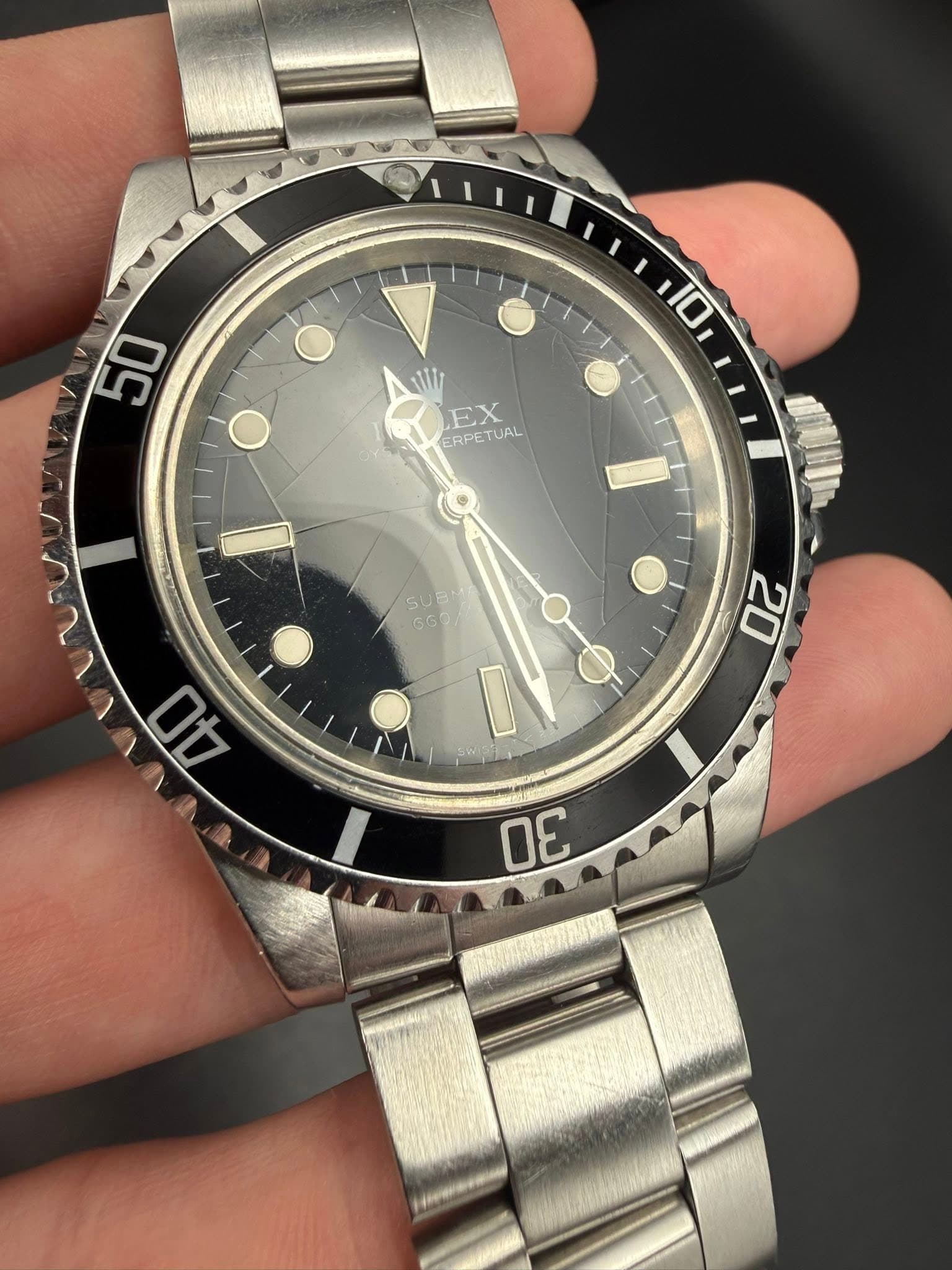 May be an image of wrist watch and text that says '50 110 EX ERPETUAL ERPET UAL VV 40 20 SUBT N በር'