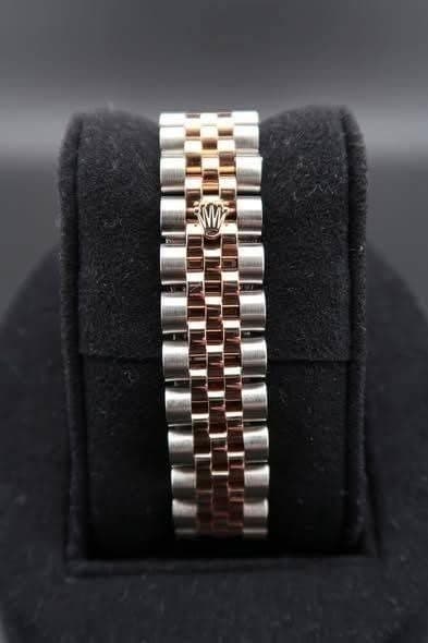 May be an image of wrist watch and jewelry