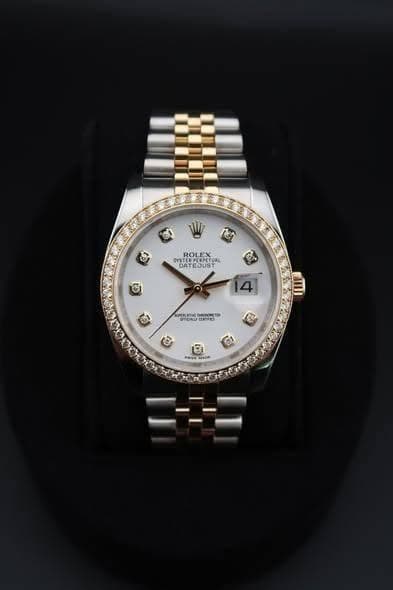 May be an image of wrist watch and text