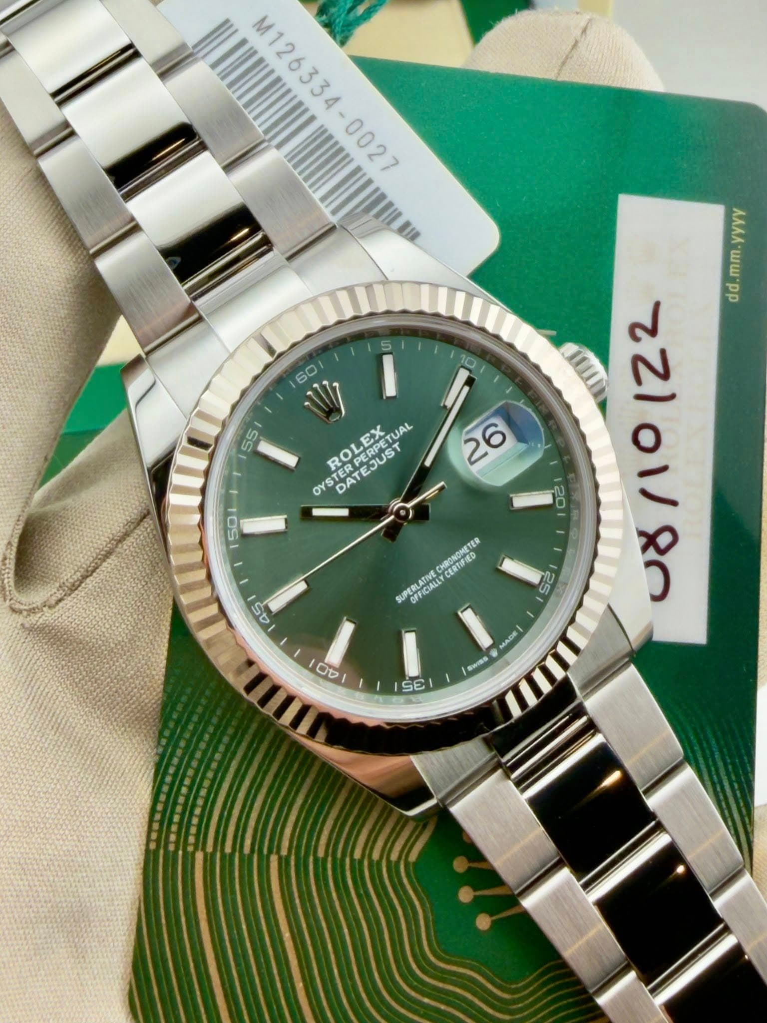 May be an image of wrist watch and text that says 'M126334-0027 M126334- w ROLEX ATEJUST PETUAL UAL PERPETU OYS TER TER DAT 26 50 K UAU م 22101/80 0ノ 122 da 20 25 e0 CHRONGMETER…