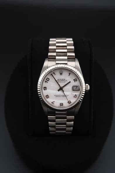 May be an image of wrist watch and text