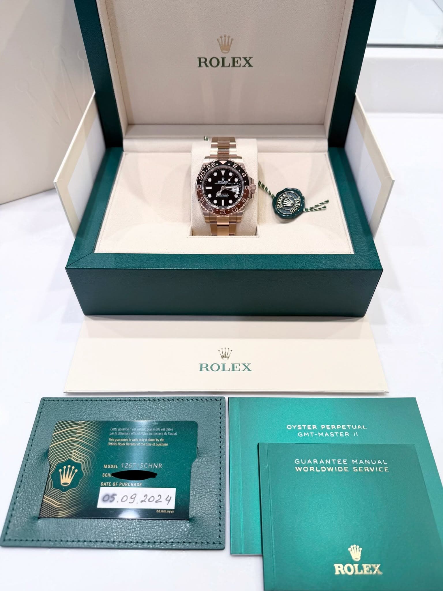 May be an image of wrist watch and text that says 'ROLEX 年 ROLEX Tele Mb/ip.laterwodudpetu OYSTERPERPETUAL OYSTER PERPETUAL GMT-MASTER MODEL 126T15CHNR SERI DATEOFPURCHASE ddem.my…