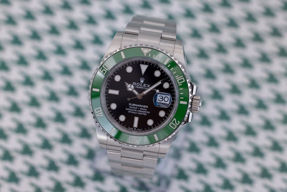 May be an image of wrist watch and text that says '10I 50 50 ROLEX RO EX PERPE 10 30 SU BMARI SUBMARINER INER *300 #FICNLLYESENTER 40 20 30'