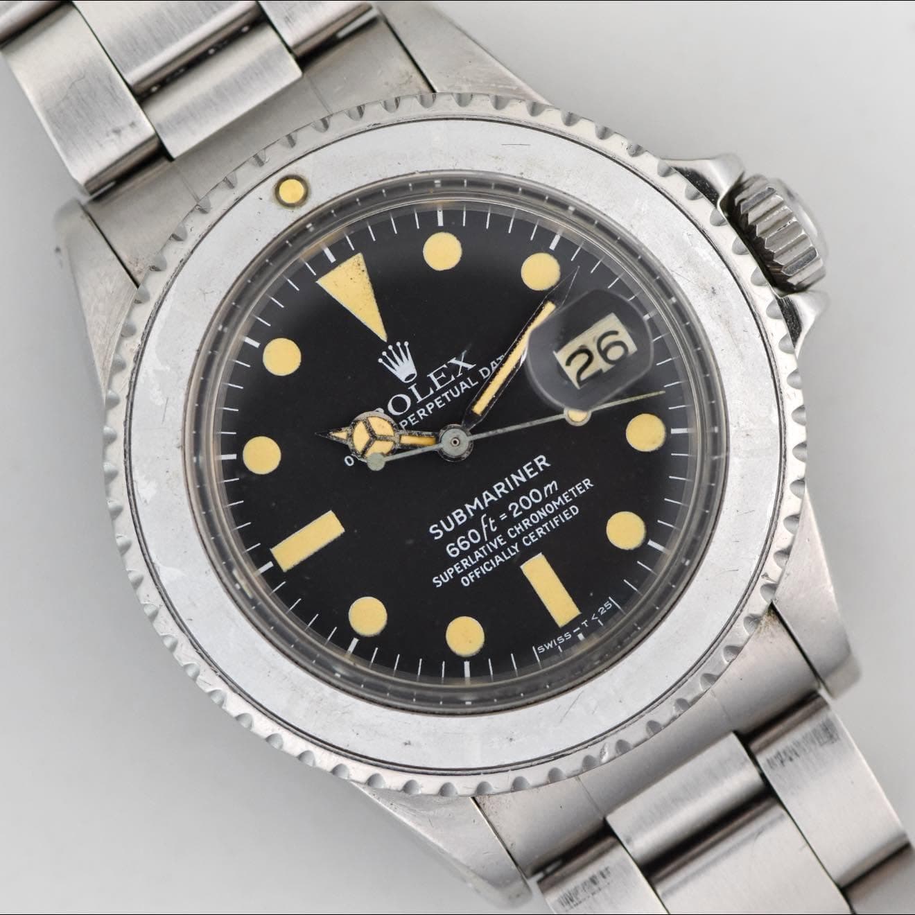 May be an image of wrist watch and text that says 'O 26 o OLEX TEY DAX PERPETUAL ETUAL SUBMARINER 200m 200MEB MRONOMETER CERTIFLED CERTIFIED RONOMETE TER SUBI 660t PERLATIVE…