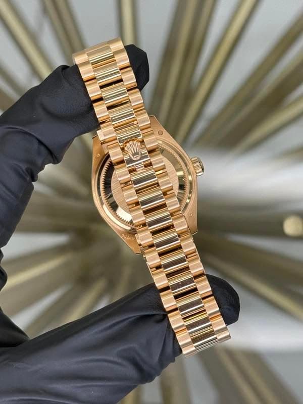 May be an image of jewelry, wrist watch and text