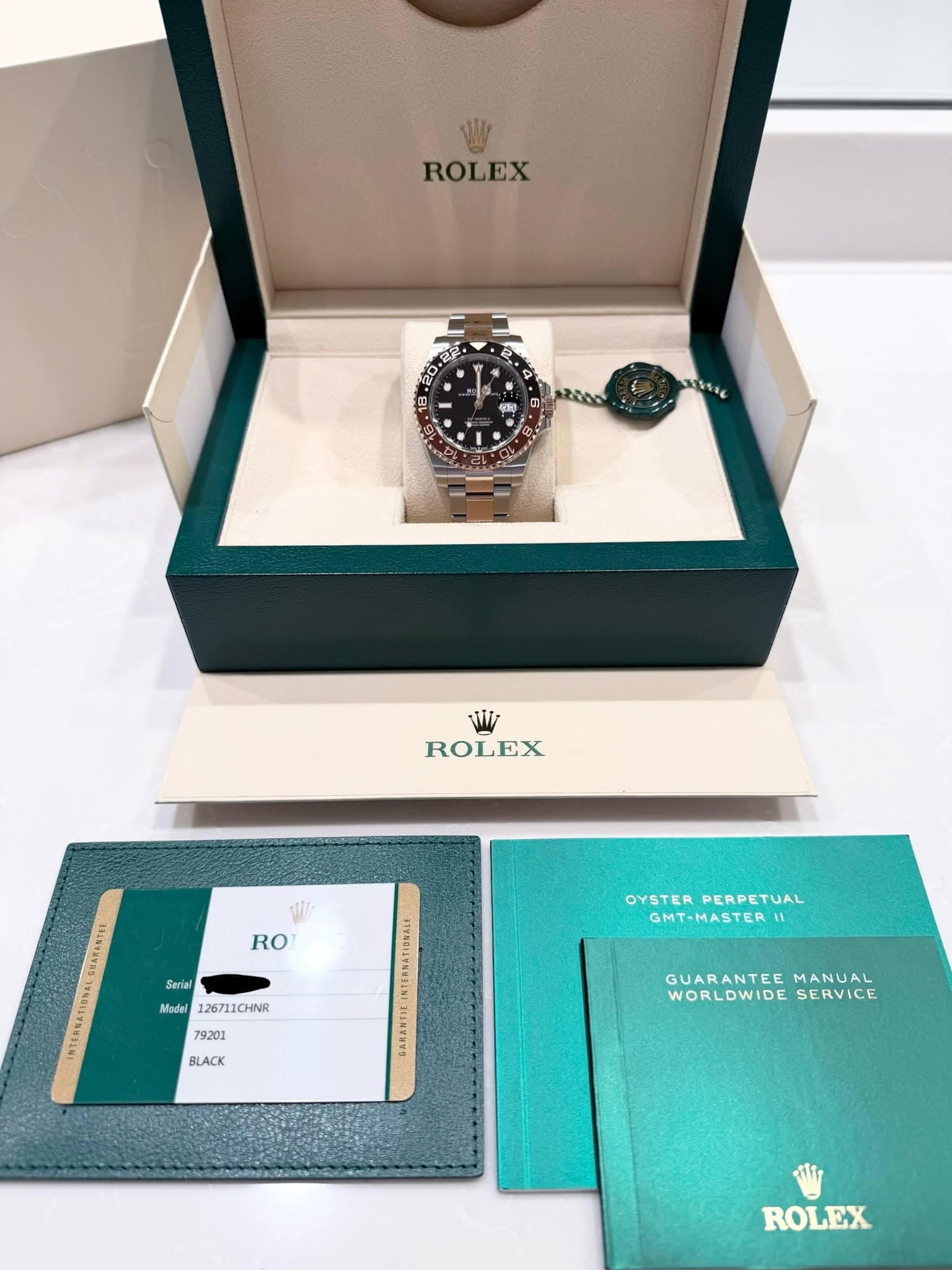 May be an image of wrist watch and text that says 'ROLEX ROLEX w RO Seriel เสงหารถ NTERN&TIONEL Msdal 126711CHINR OYSTER OYSTERPERPETUAL PERPETUAL GMT-MASTER 79201 BLACK BARAMTIE…