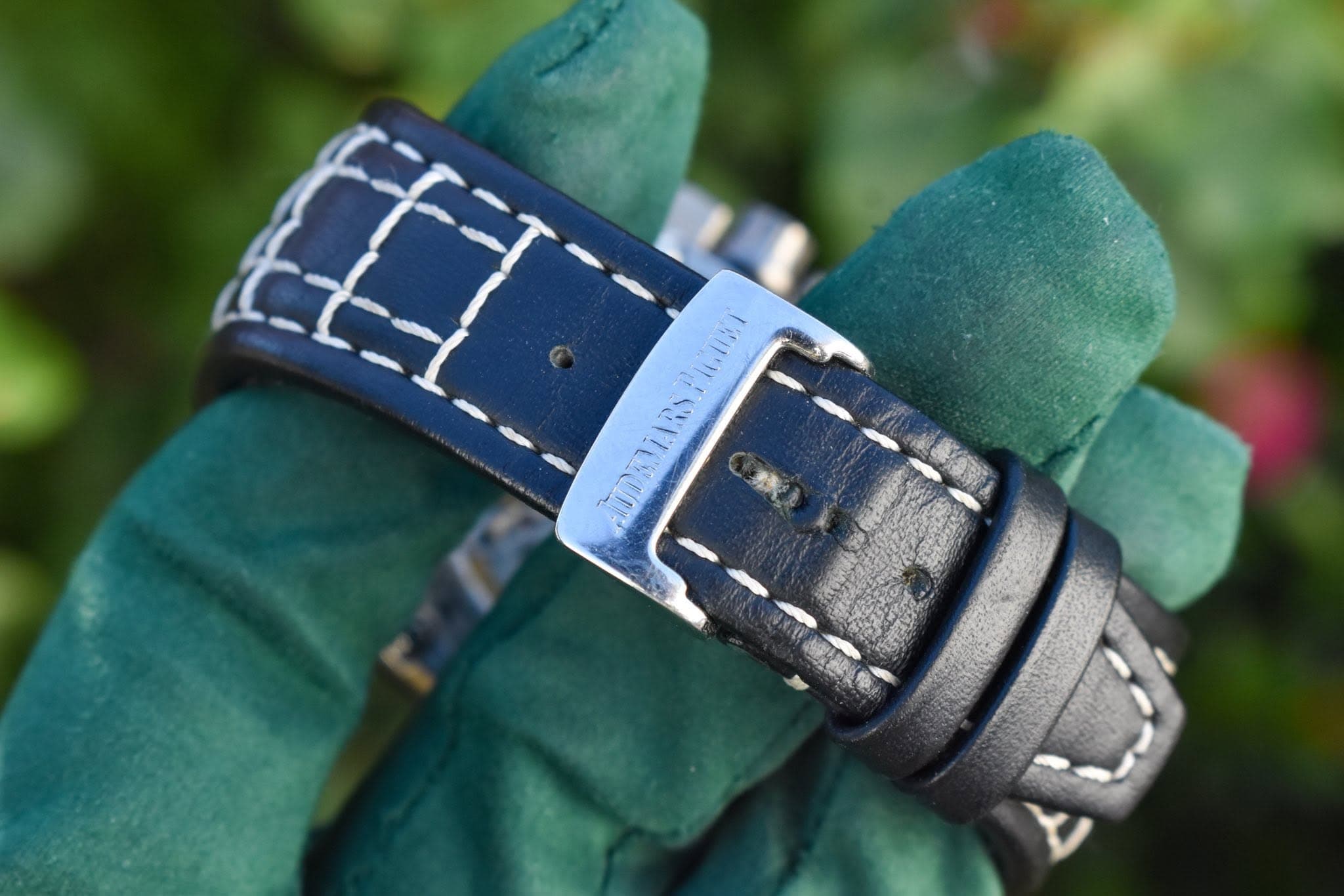 May be an image of saddle-stitched leather, wrist watch and text