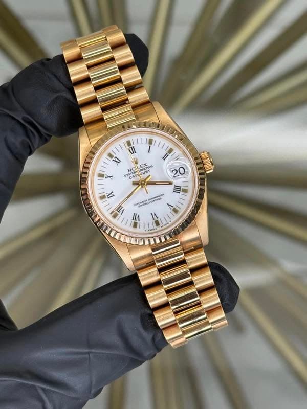 May be an image of wrist watch and text