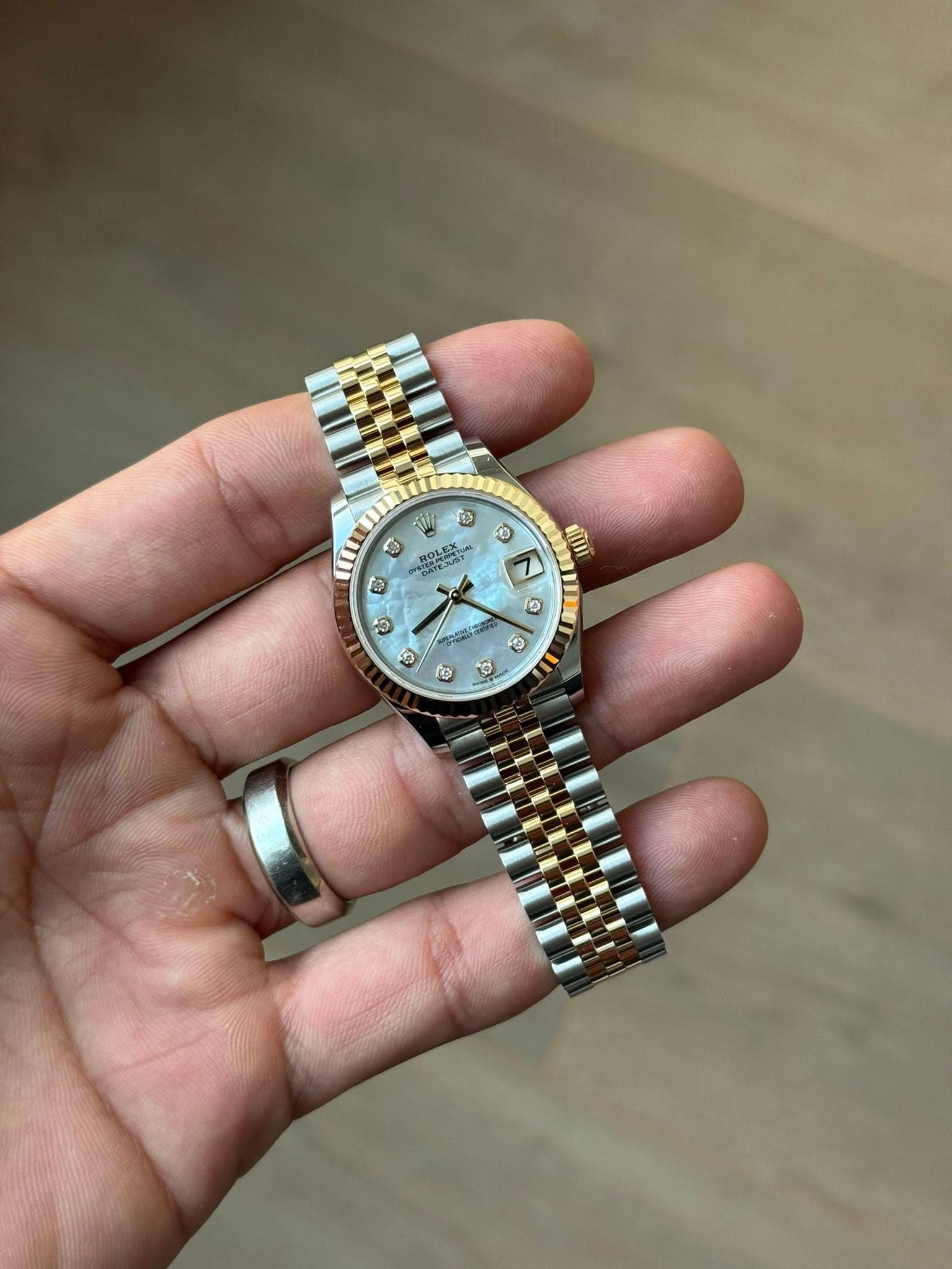 May be an image of wrist watch and text