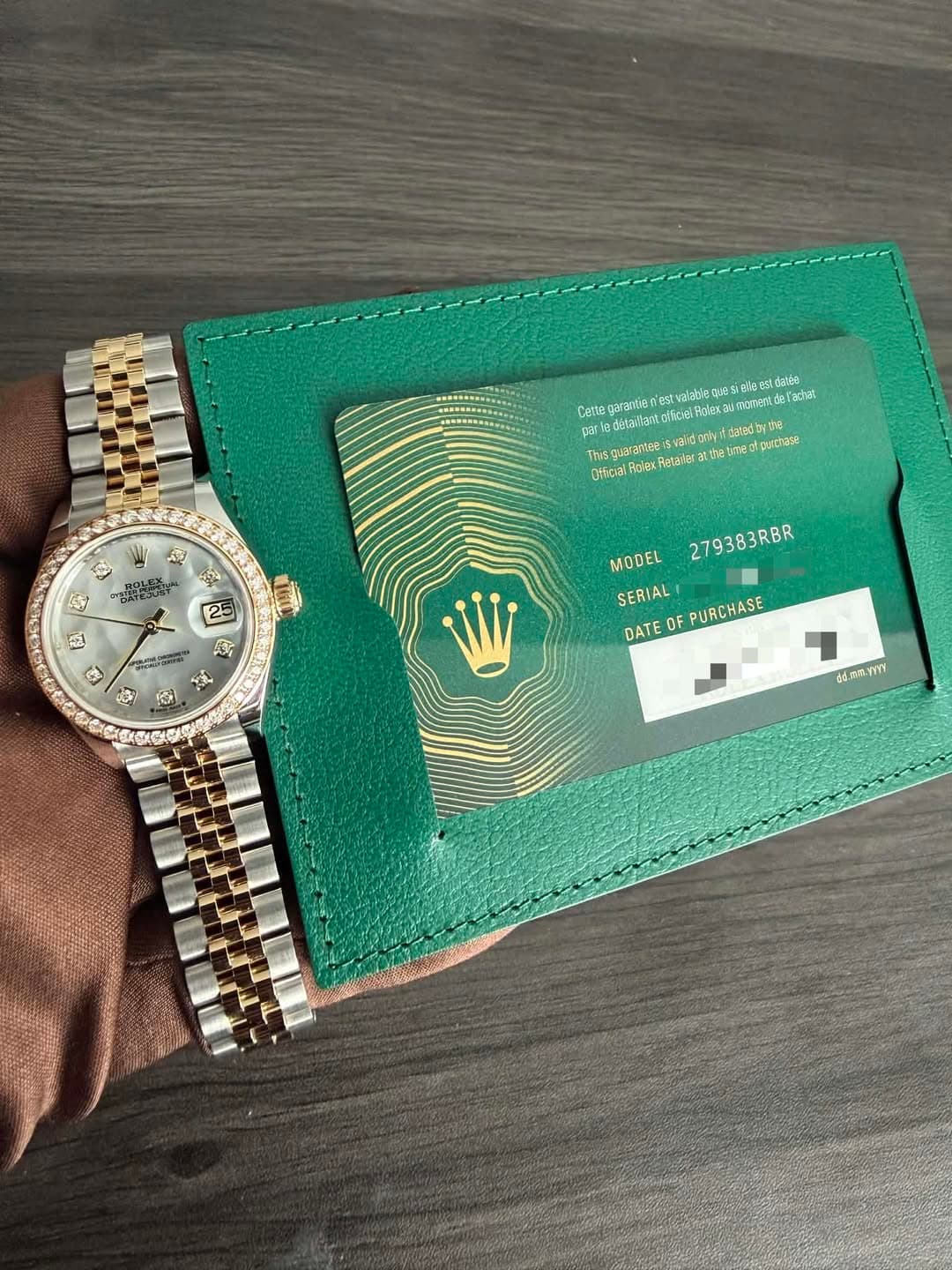 May be an image of wrist watch, leather wallet and text