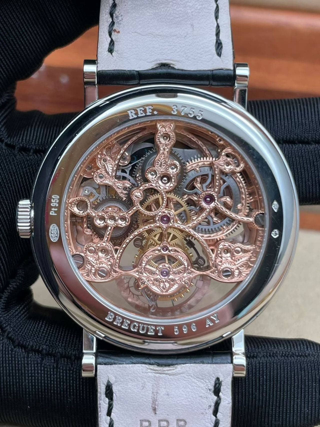 May be an image of wrist watch and text that says 'REF. 3755 CO Pt 950 SLOR Rp 0 3 BREGUET 596 AY'