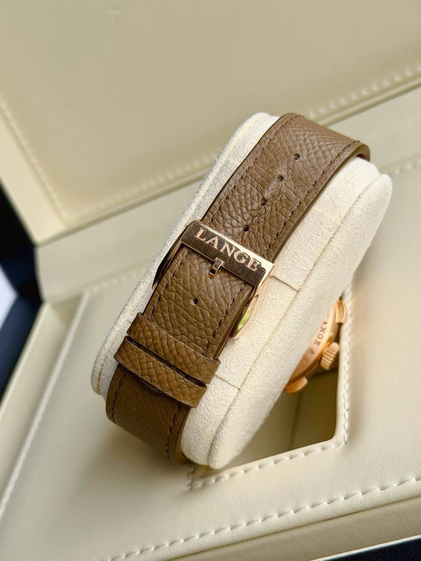 May be an image of wrist watch, leather, saddle-stitched leather and text that says 'LANGE NGE ANGE'