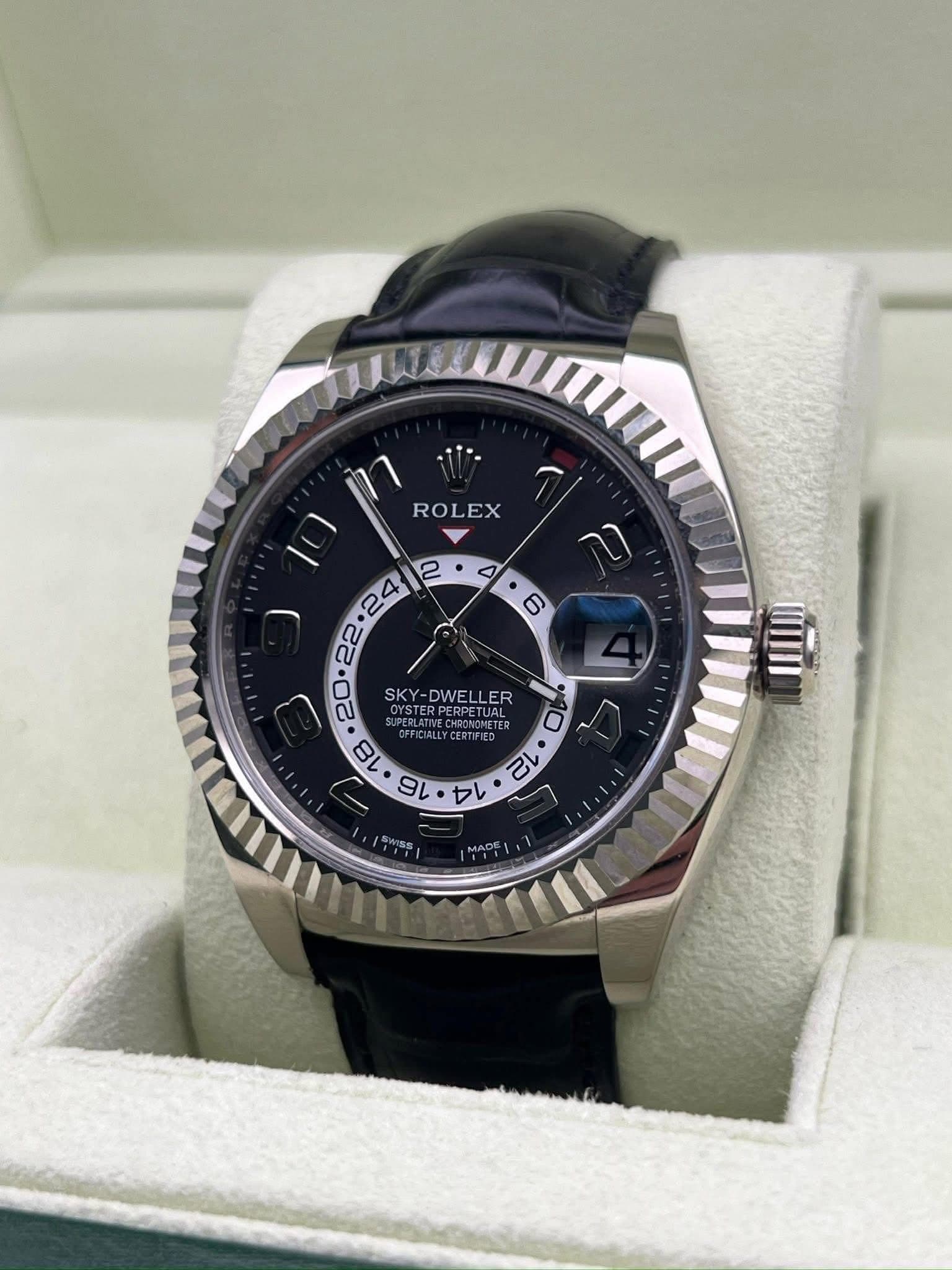 May be an image of wrist watch and text that says 'ROLEX E SKY-DWELLER OYSTERPERPETUAL SKY DWE DWELLER ER PERPETUAL FFICIALLY 18 VDAI oл CIALLYCERTIFIED CERTIFIED UAL TER TEP 16 14…