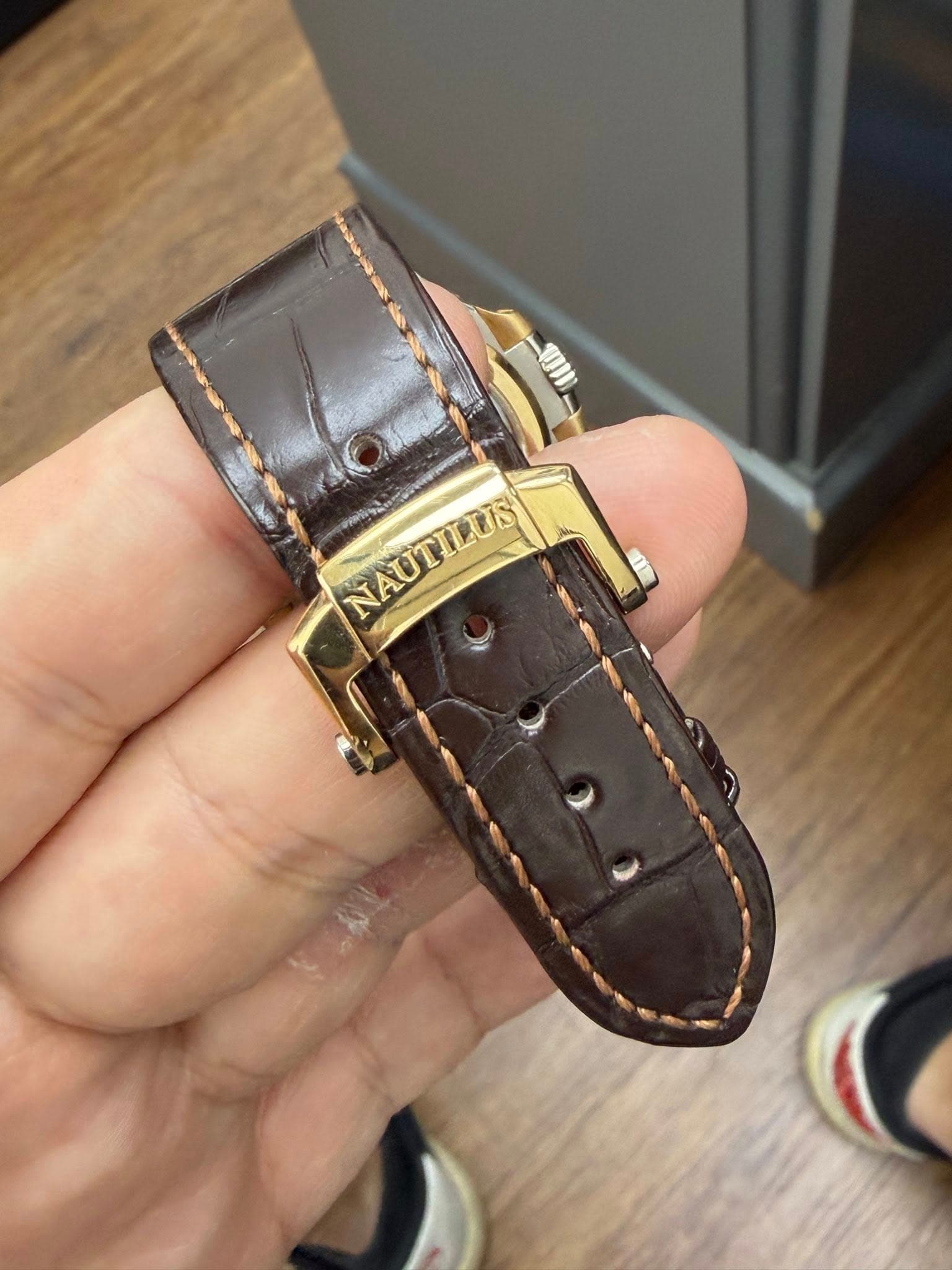 May be an image of wrist watch and text that says 'NAUTILUS'