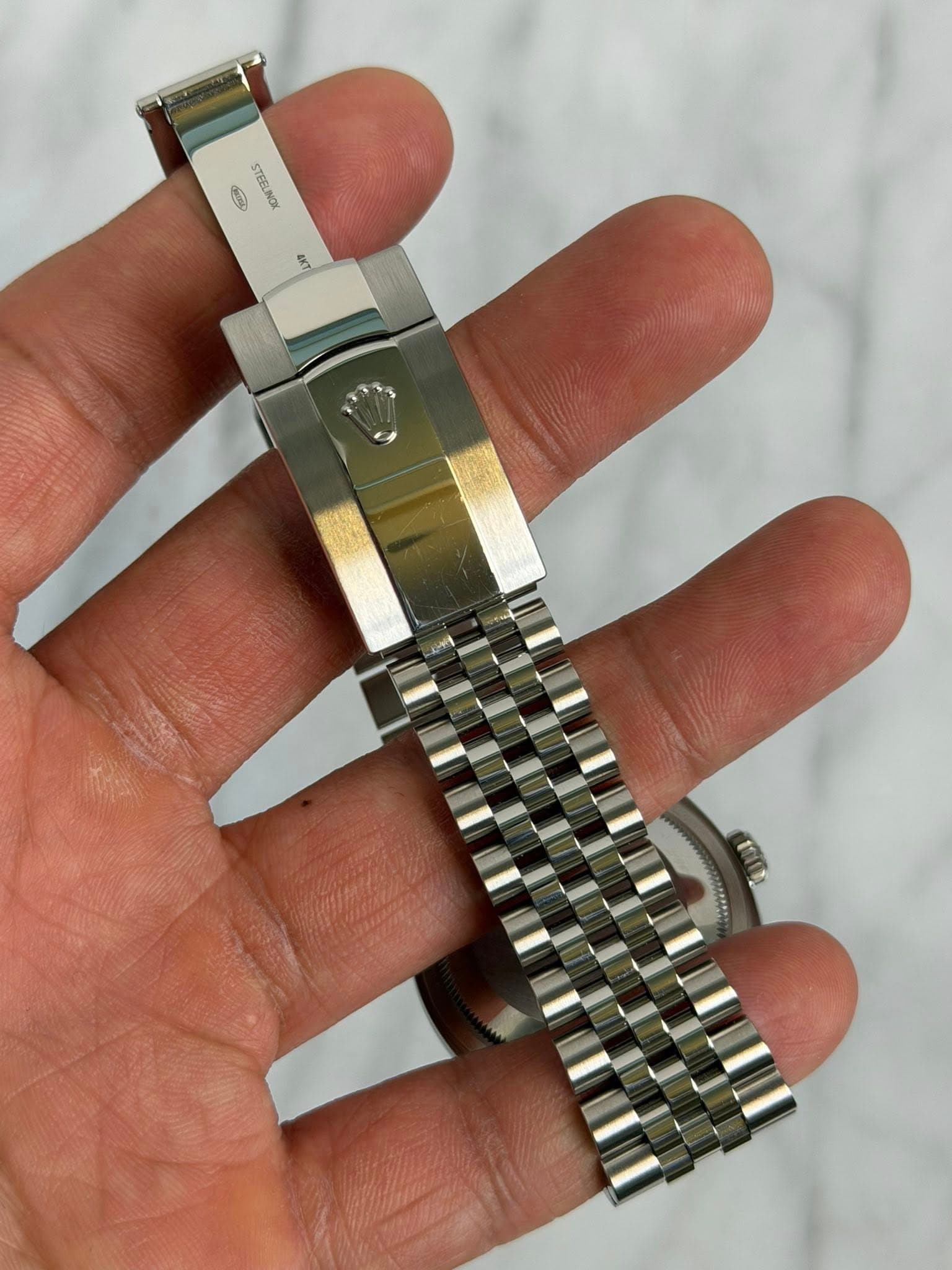 May be an image of wrist watch and text
