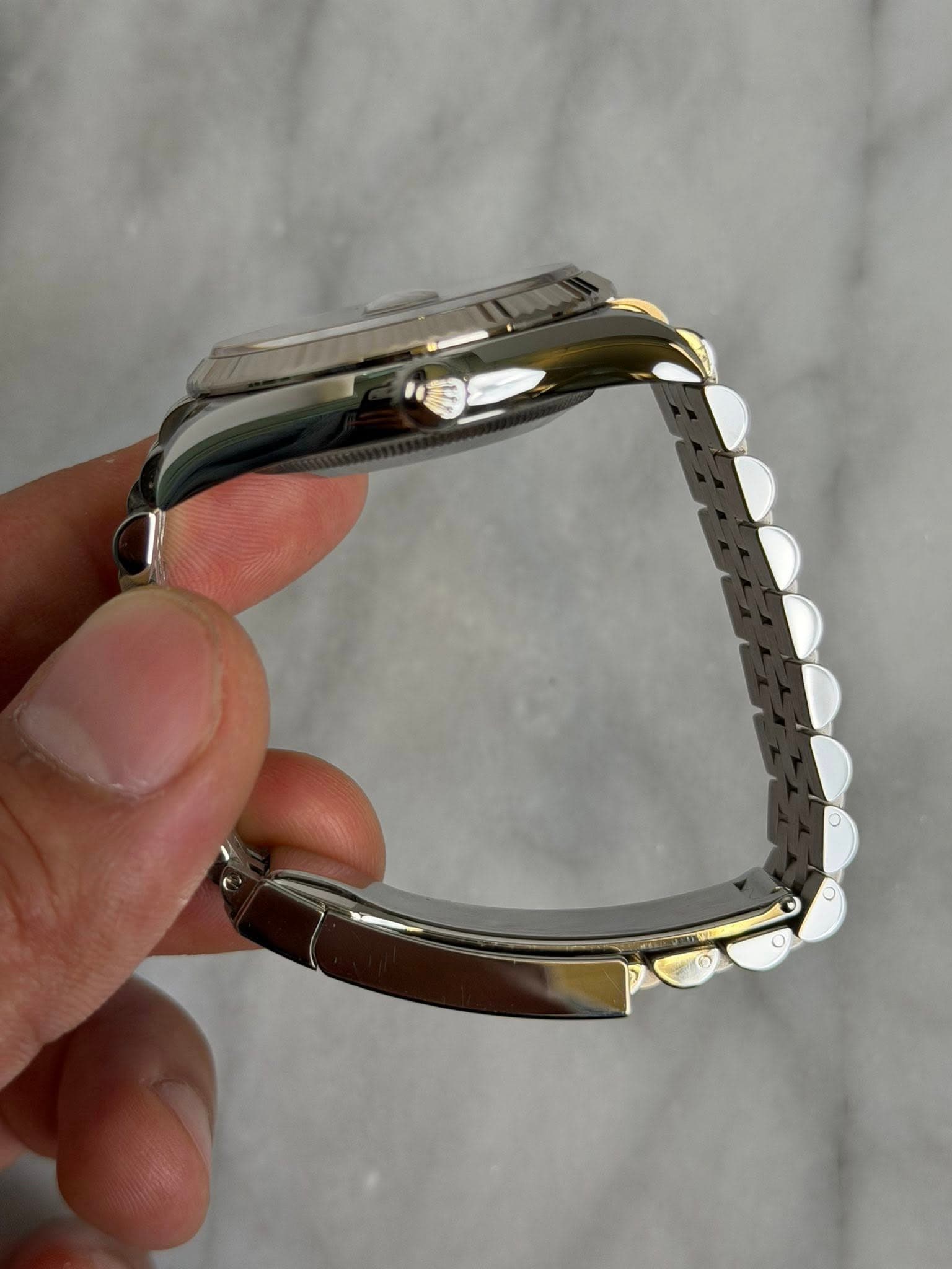 May be an image of wrist watch and jewelry