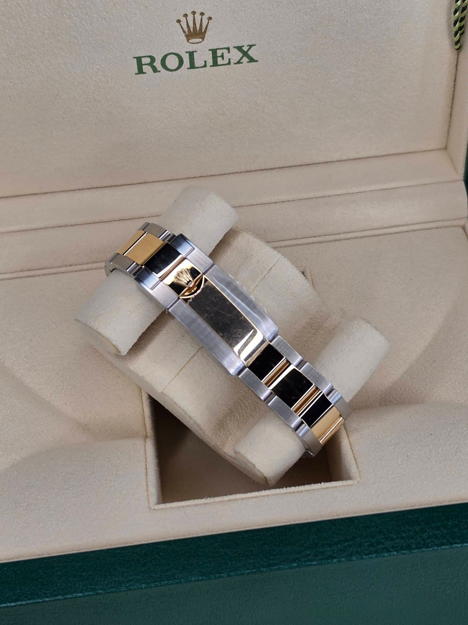 May be an image of wrist watch, ring and text that says 'ROLEX'