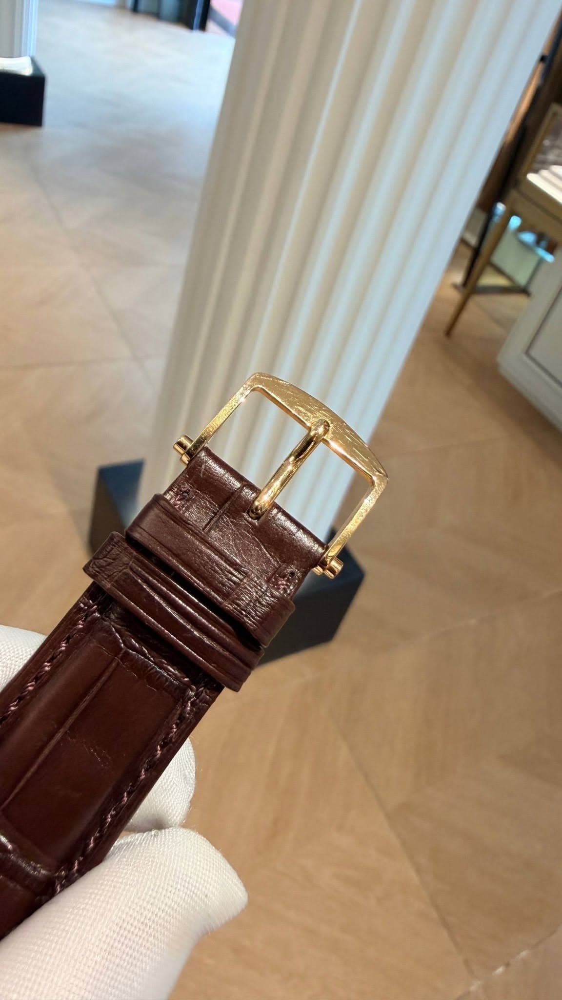 May be an image of saddle-stitched leather, wrist watch and text
