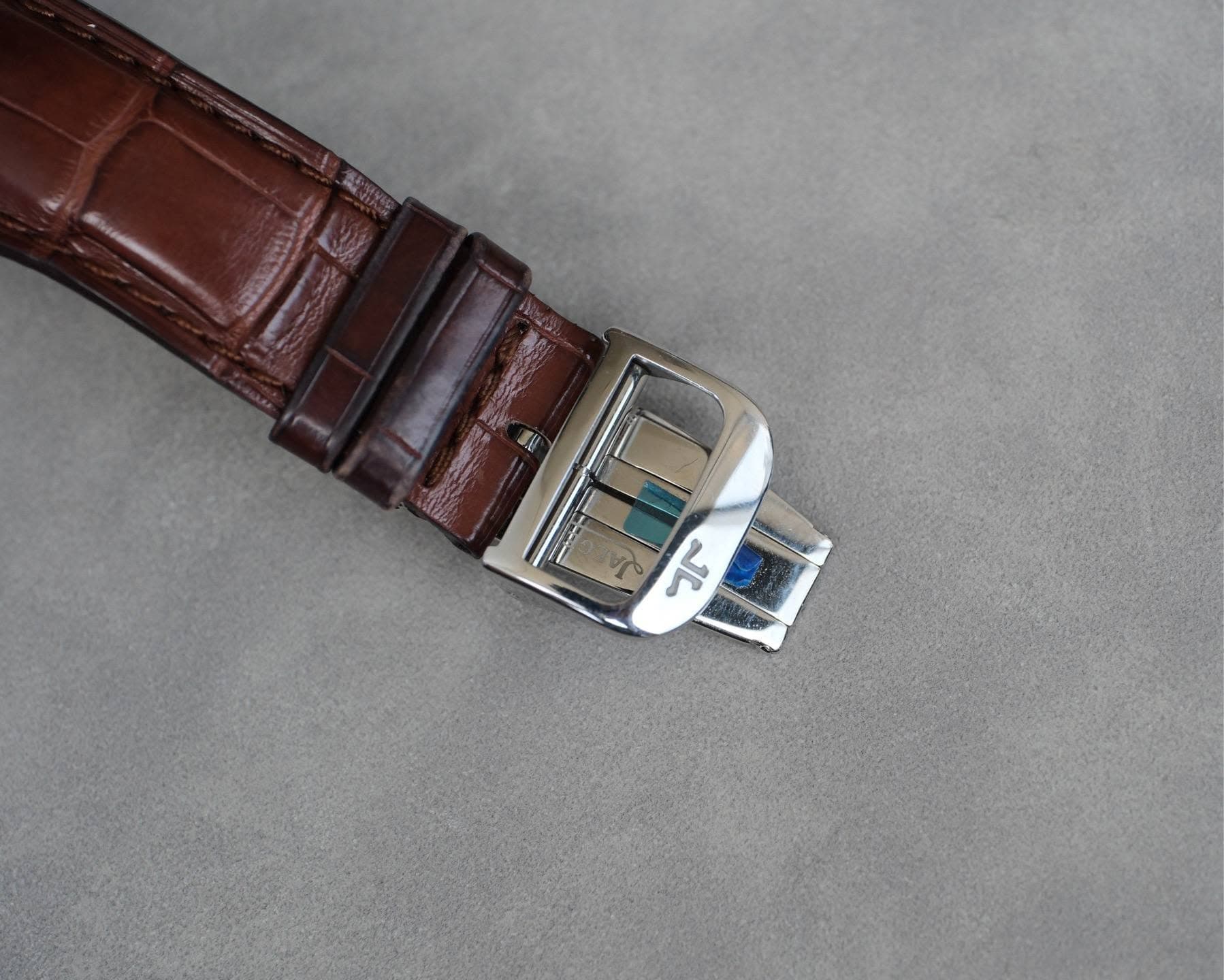 May be an image of saddle-stitched leather, leather and wrist watch
