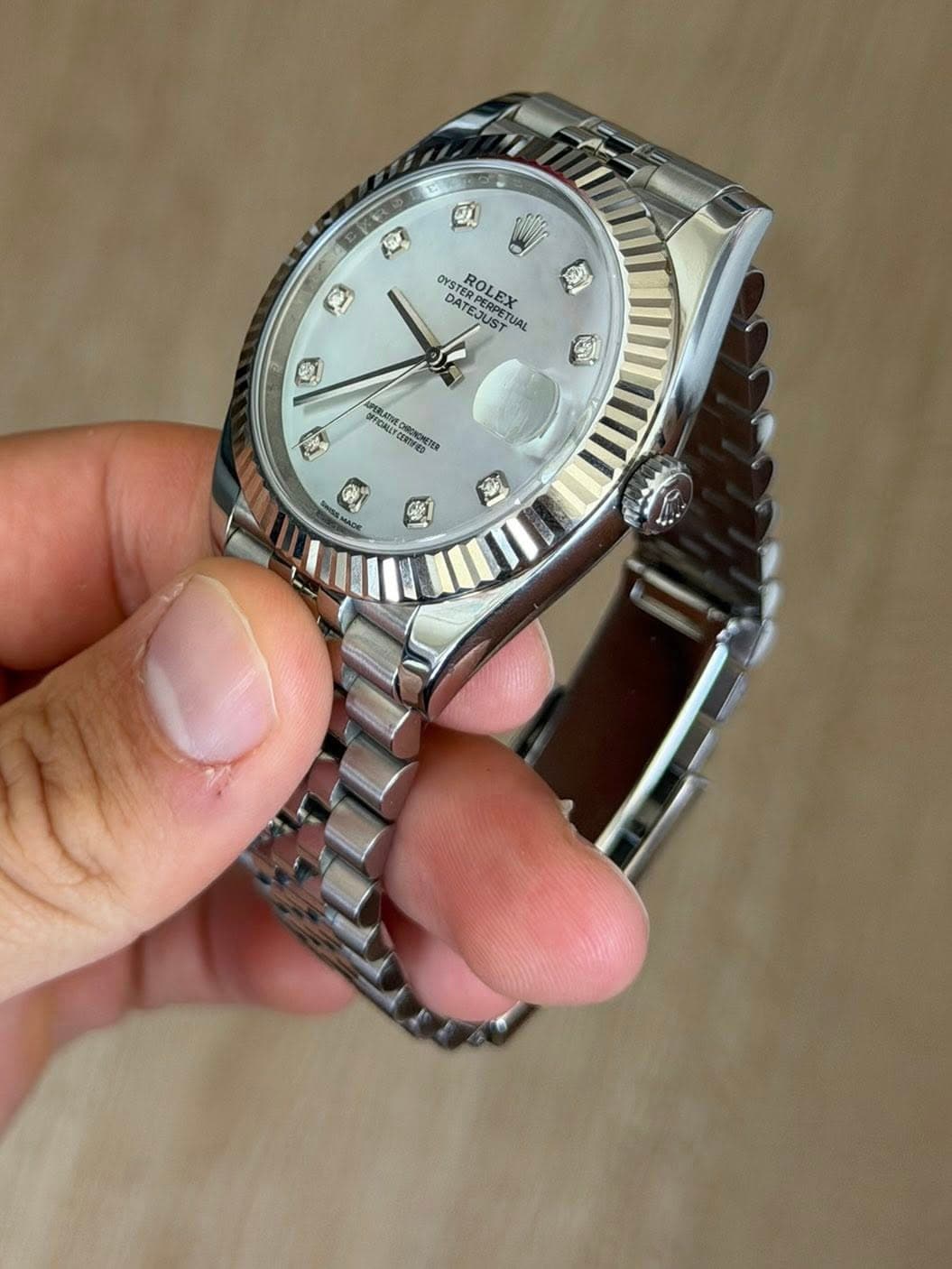 May be an image of wrist watch and text
