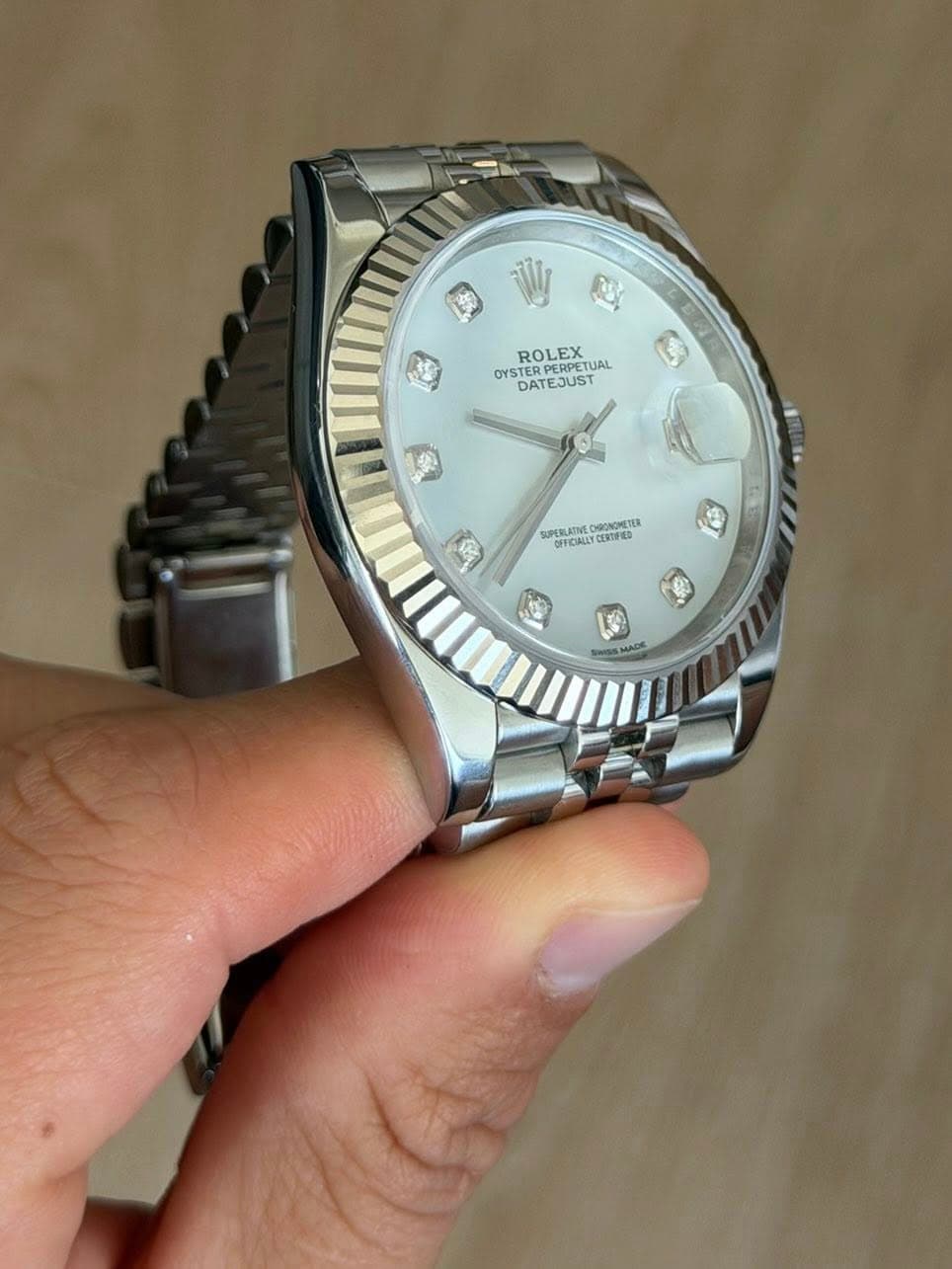 May be an image of wrist watch and text