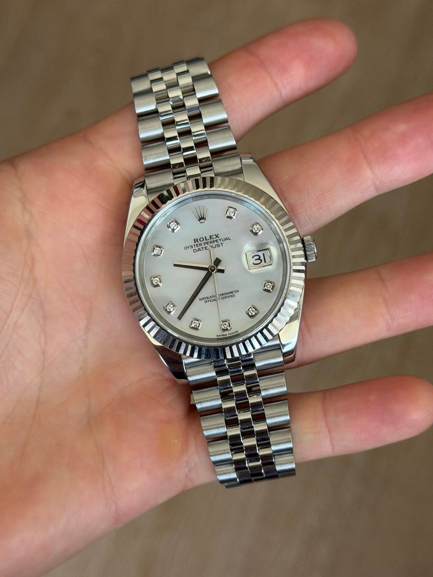 May be an image of wrist watch and text