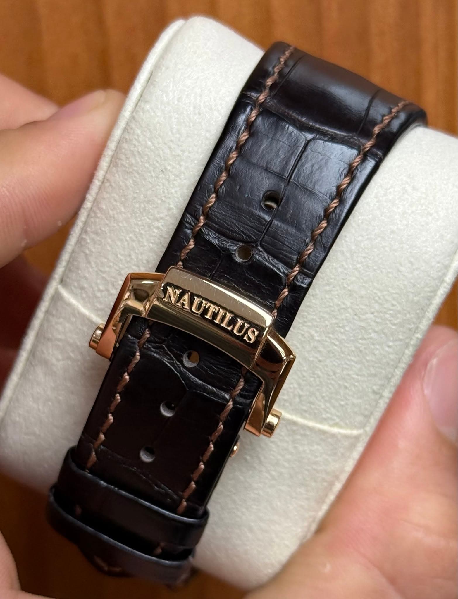 May be an image of wrist watch and text that says 'T NAUTILUS NAUTILUS'
