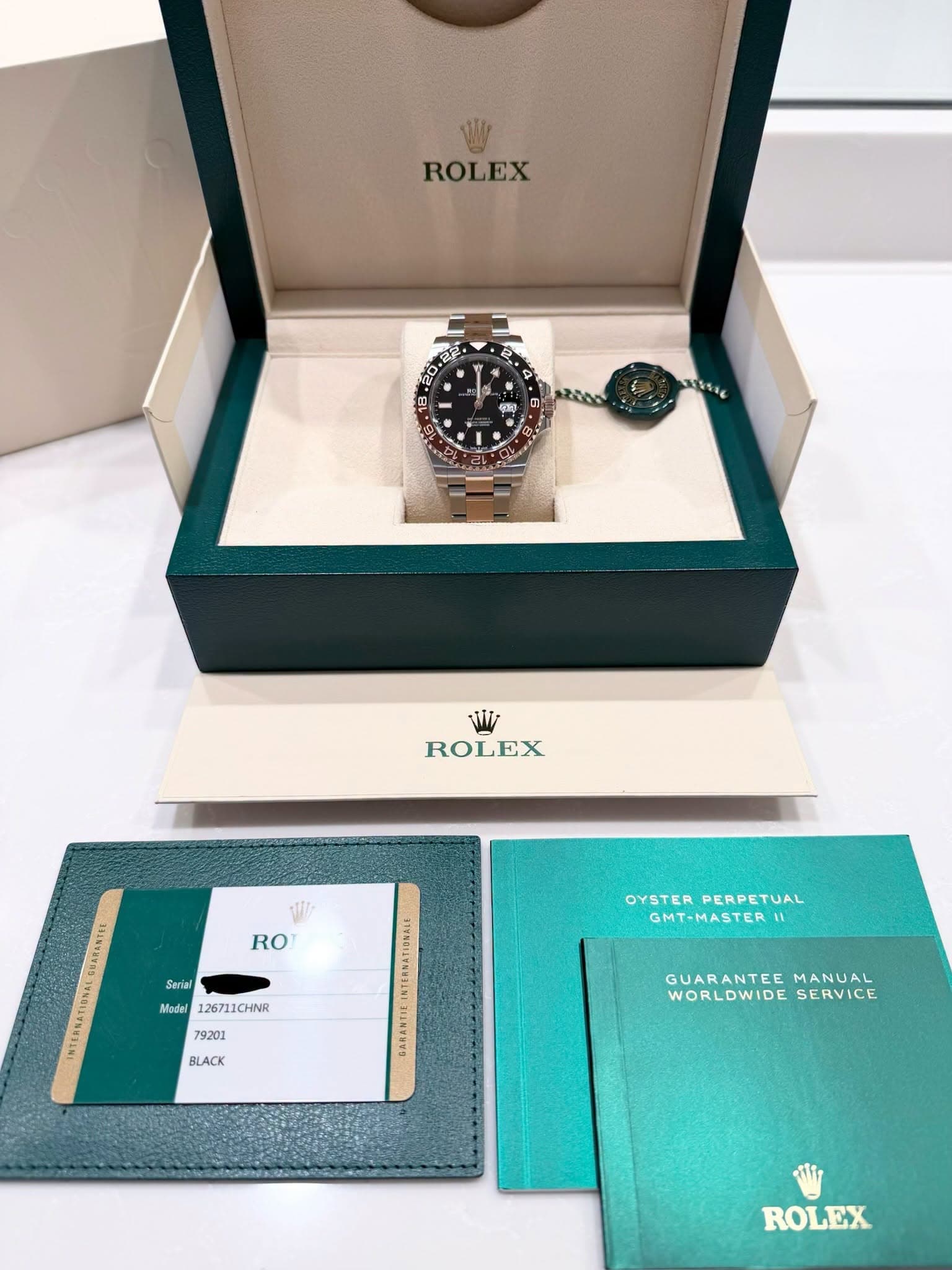 May be an image of wrist watch and text that says 'ROLEX ROLEX W RO SARANTIG NTERNETIONEL Seriel Msdal 126711CHINR 126711 1CHNR OYSTER OYSTERPERPETUAL PERPETUAL GMT-MASTERI 79201…