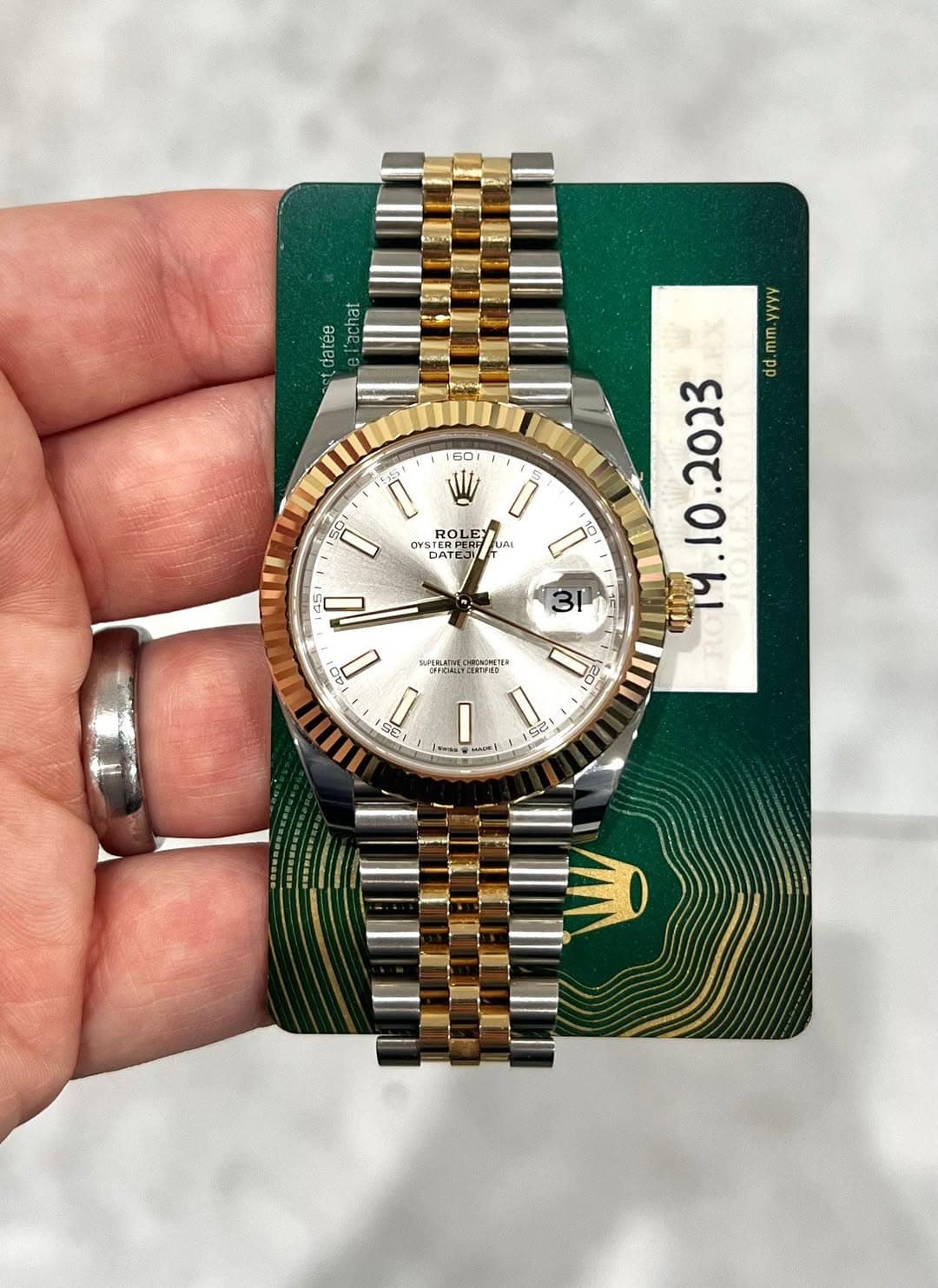 May be an image of wrist watch and text