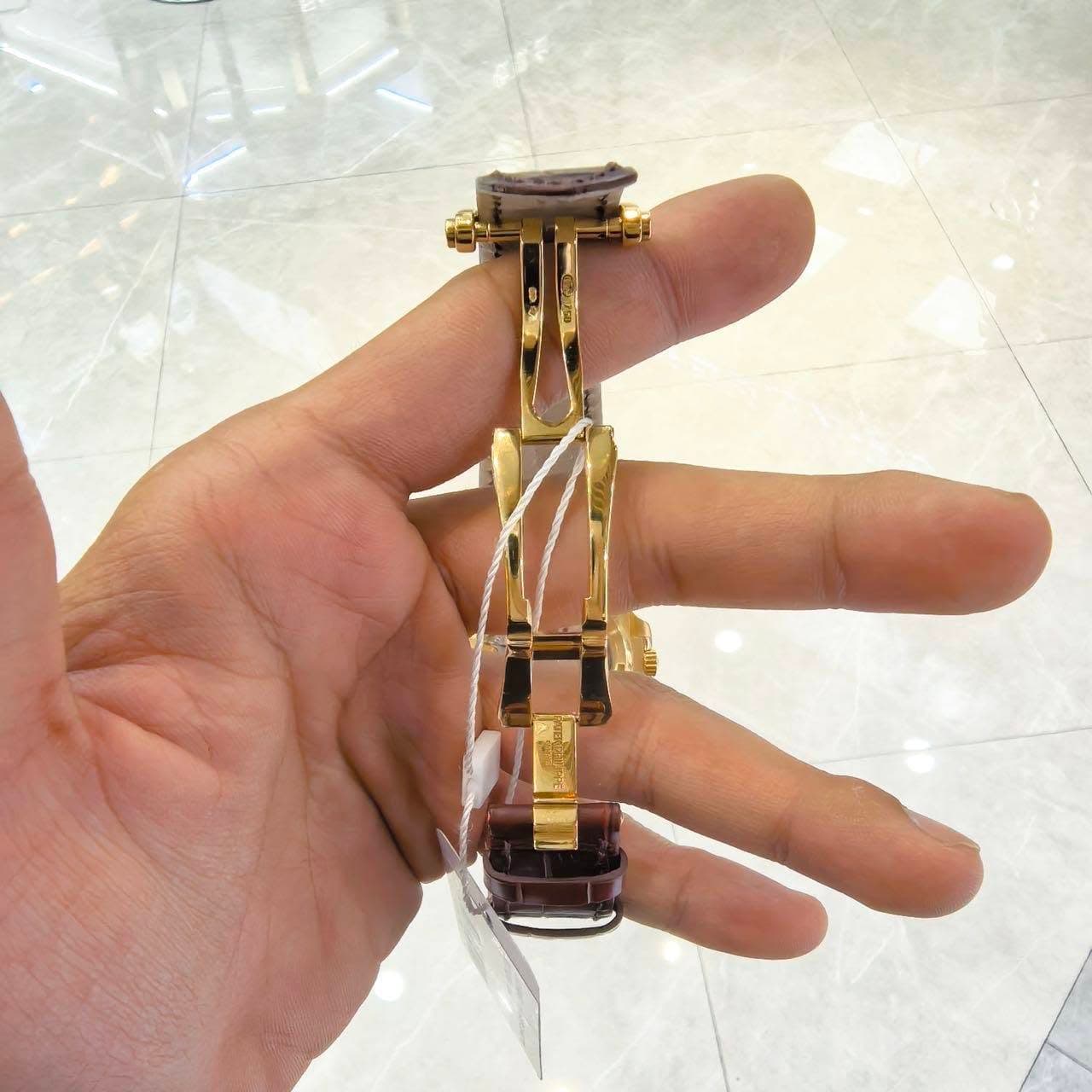 May be an image of cufflinks, wrist watch and jewelry