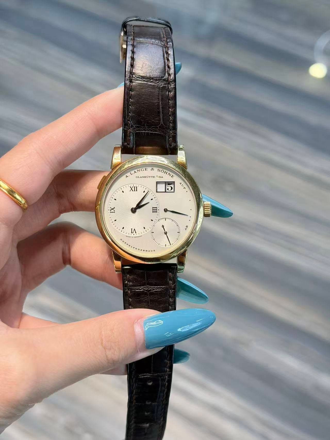 May be an image of jewelry, wrist watch and text