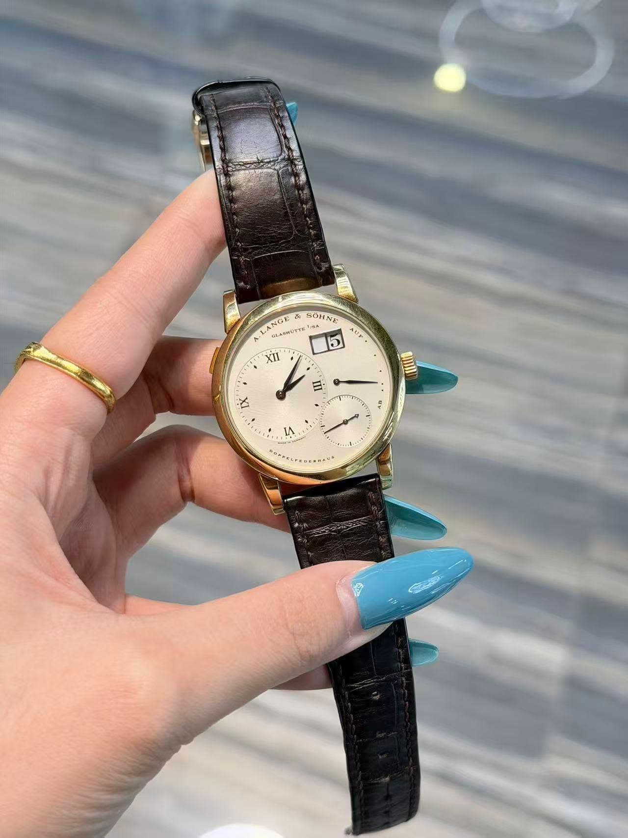 May be an image of wrist watch and text