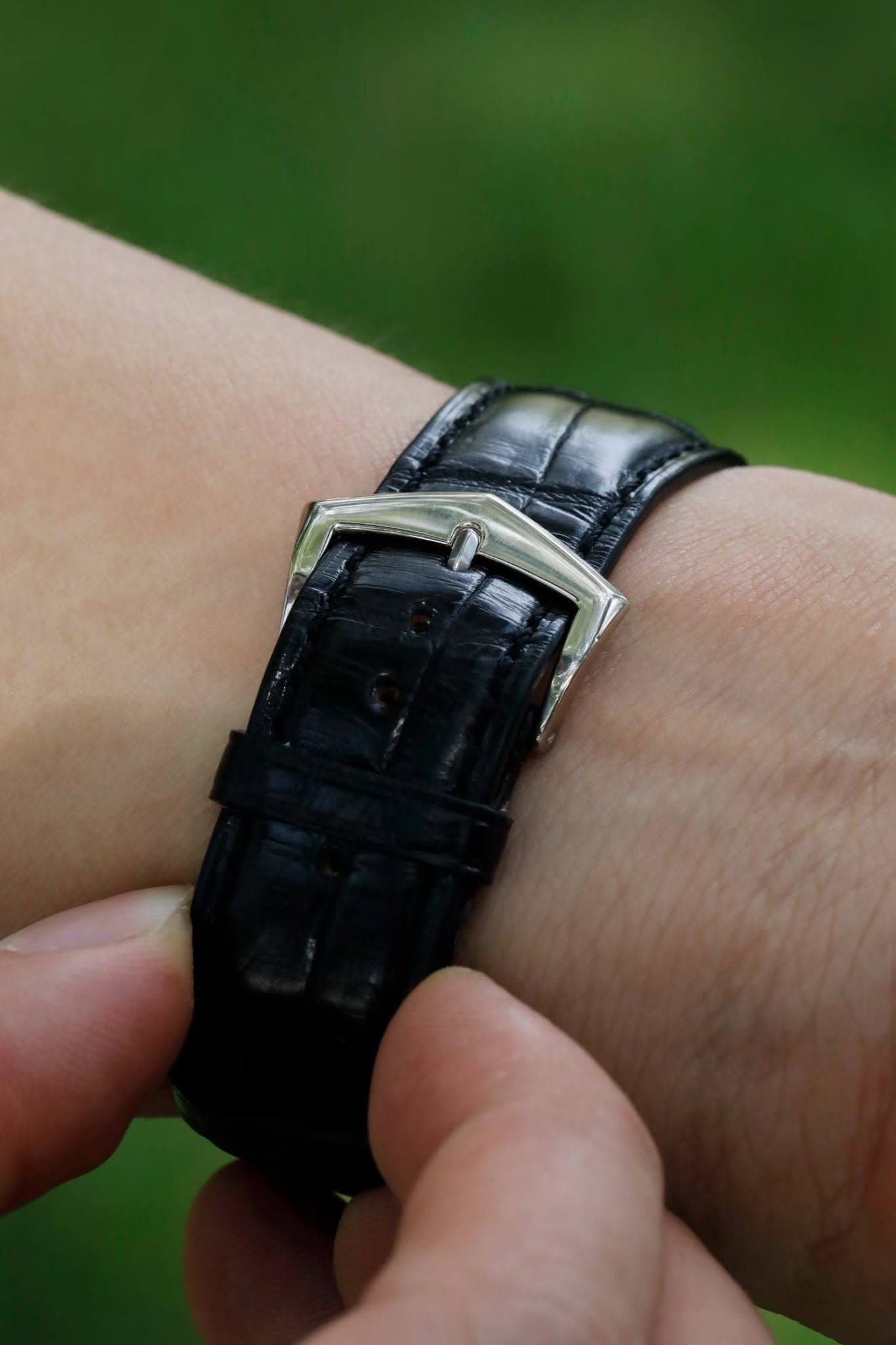 May be an image of saddle-stitched leather and wrist watch