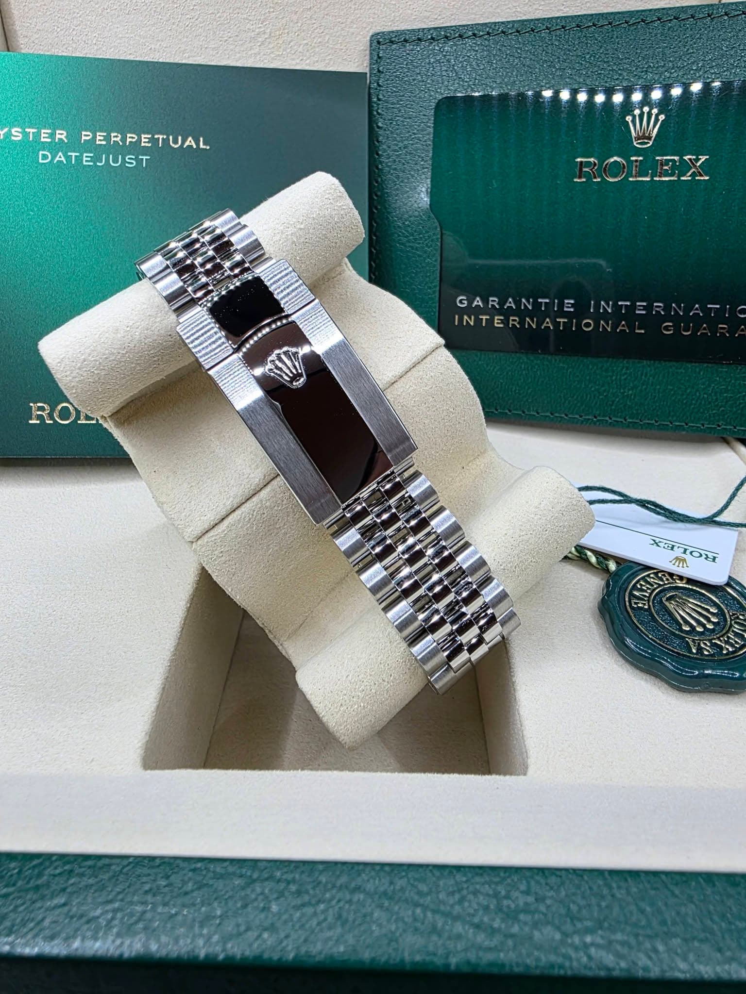 May be an image of jewelry, wrist watch and text