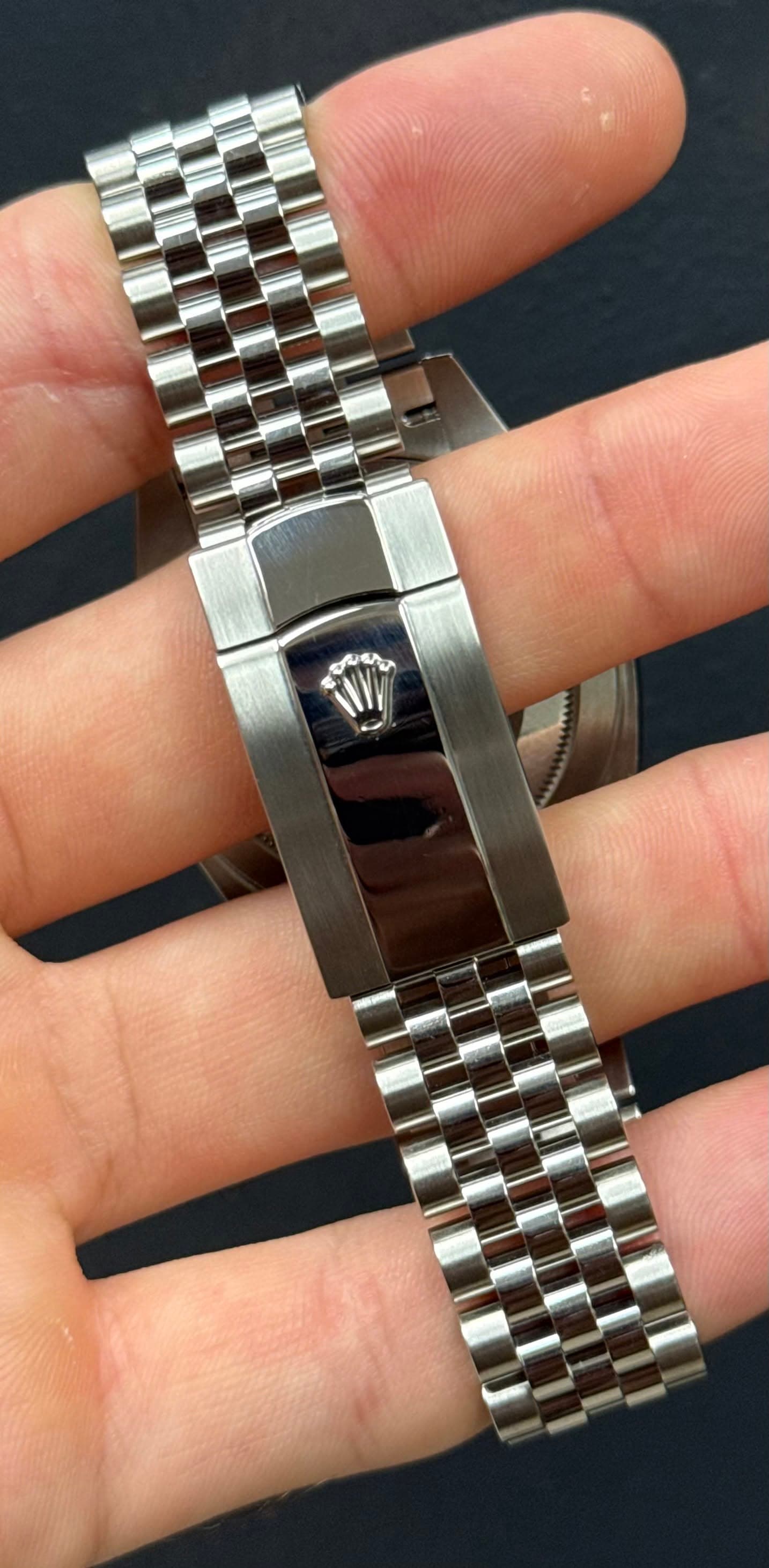 May be an image of wrist watch and text
