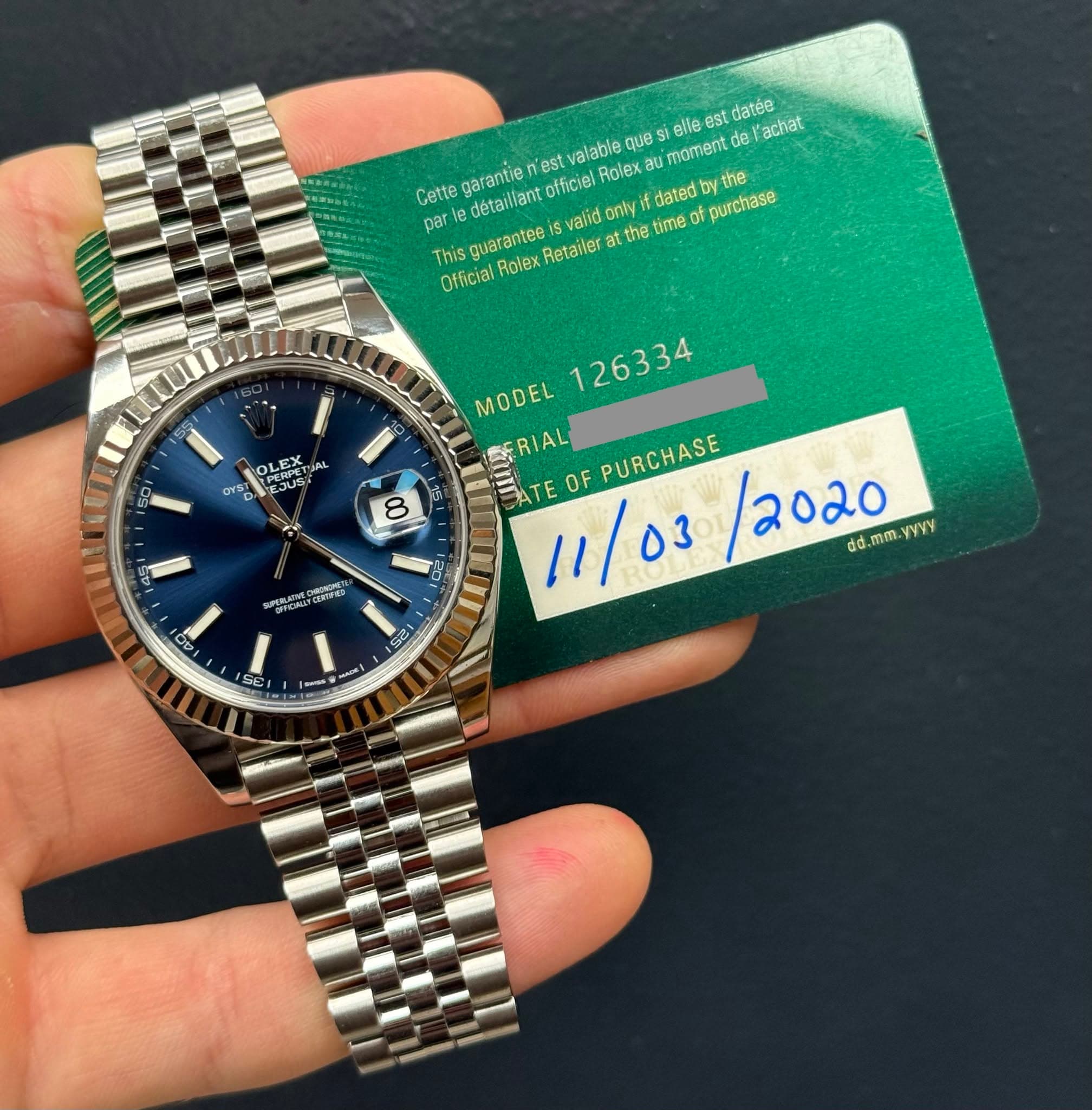May be an image of wrist watch and text that says 'slle datée l'achat Gette detailiant officiel Rolex garentie est alabla que moment parie onty dated ឋ៉ាន Official Thisguarantee…