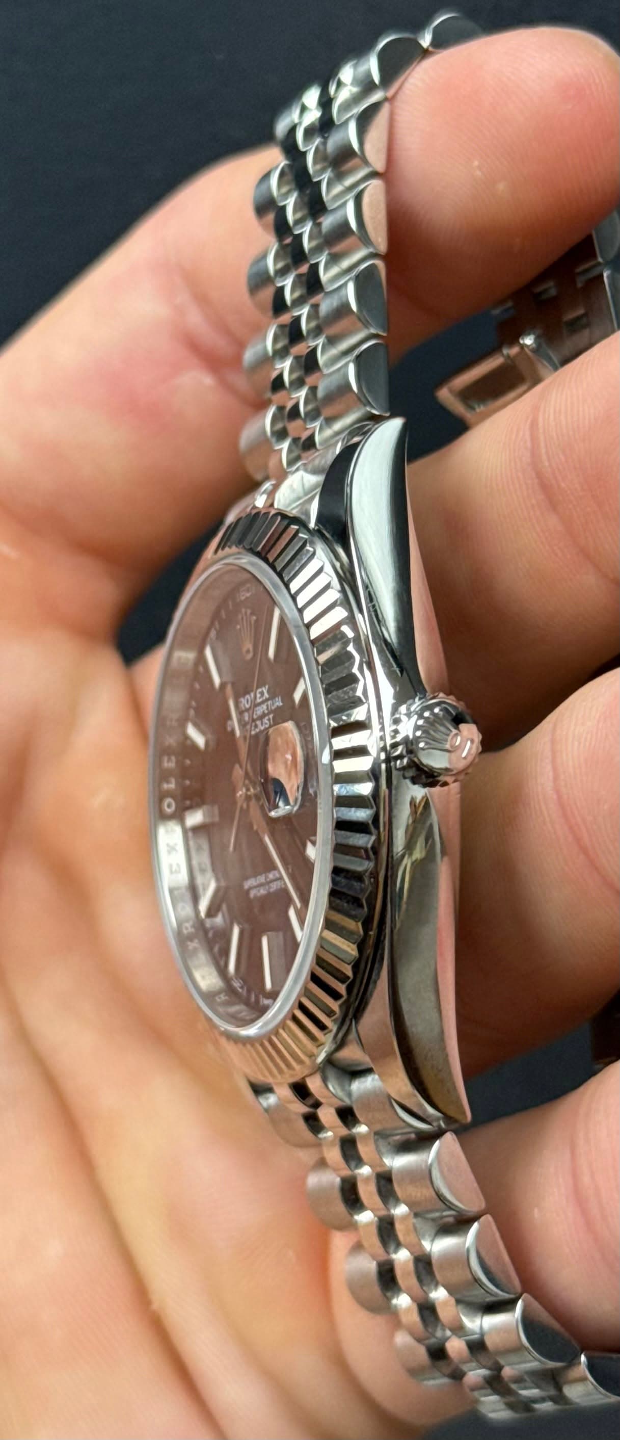 May be an image of wrist watch and text