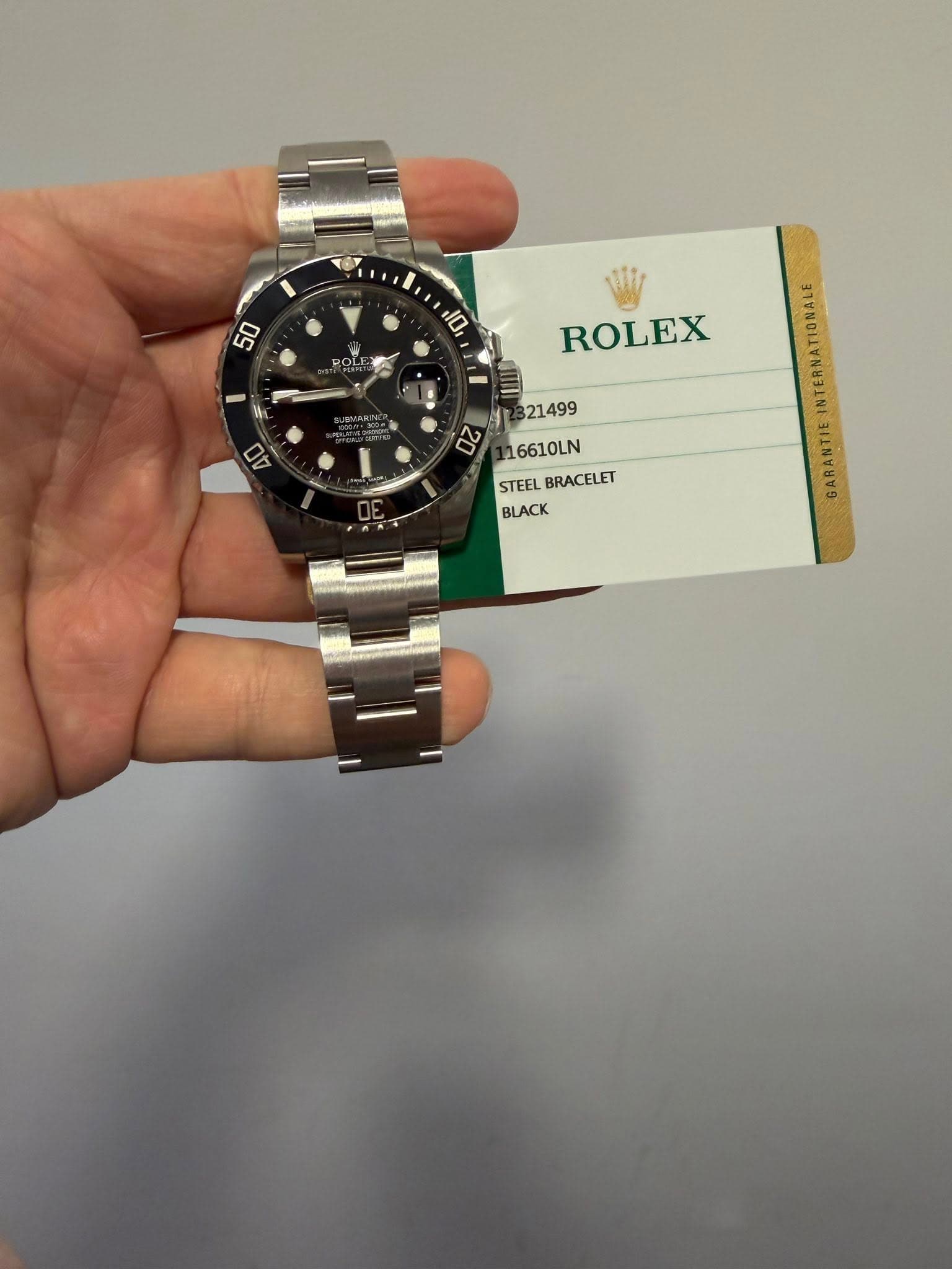 May be an image of wrist watch and text that says '50 יסוי - 5 每一 N 07 D ROLEX 21499 16610LN STEEL STEELBRACELET BRACELET BLACK GARANTIE'