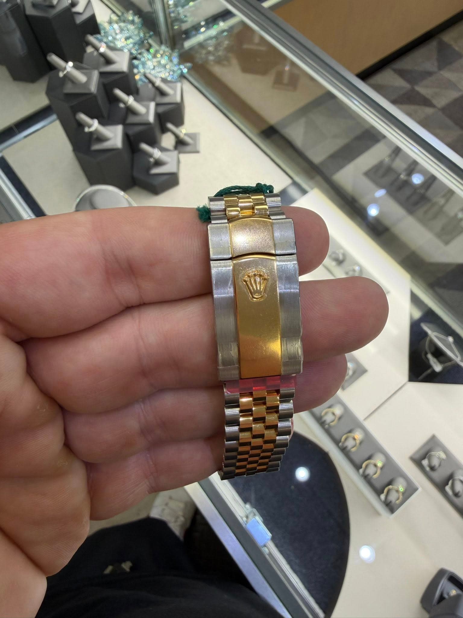 May be an image of jewelry, wrist watch and text