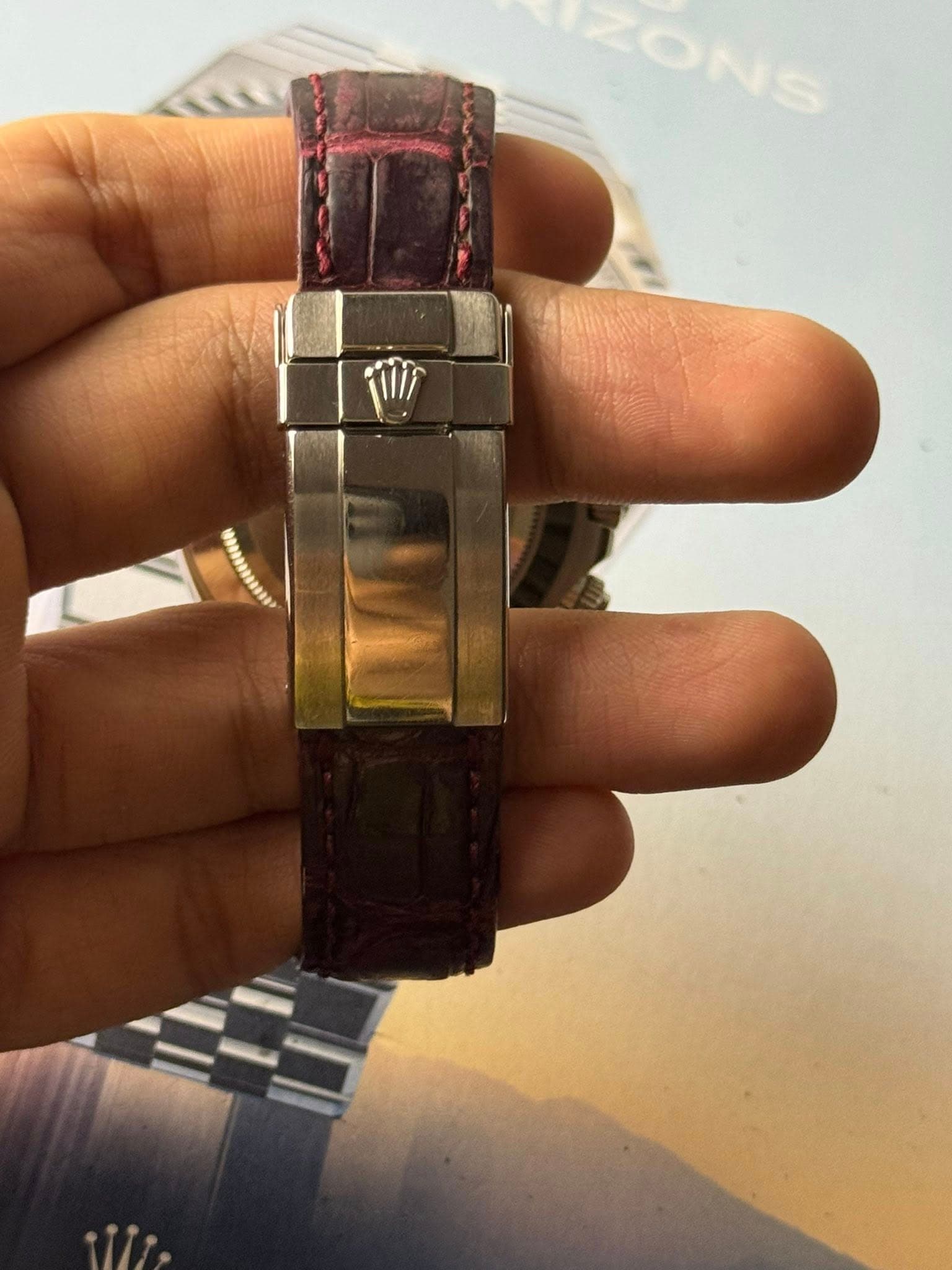 May be an image of wrist watch and text