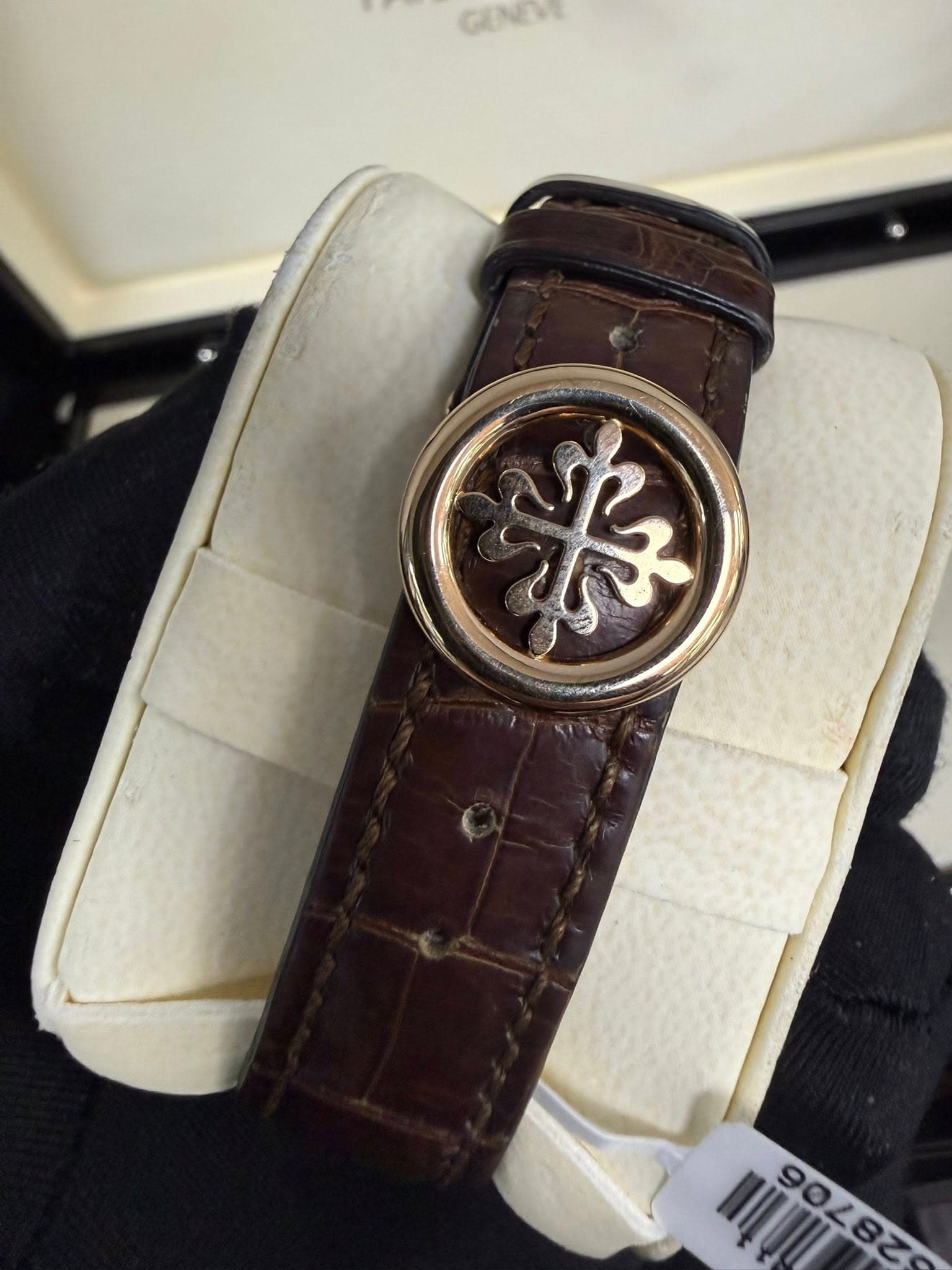 May be an image of leather, wrist watch and text