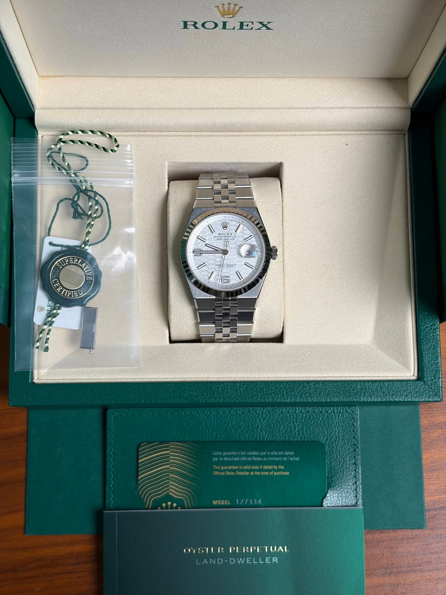 May be an image of wrist watch and text that says 'V ROLEX I1 I บ የዕቶዩ 31 RLATI ERTIFIED 6 .២" pwalawsniduke/adby จ. MODEL MODEL127334 127334 OYSTERPERPETUAL PI RPE TUAL OYSTER…