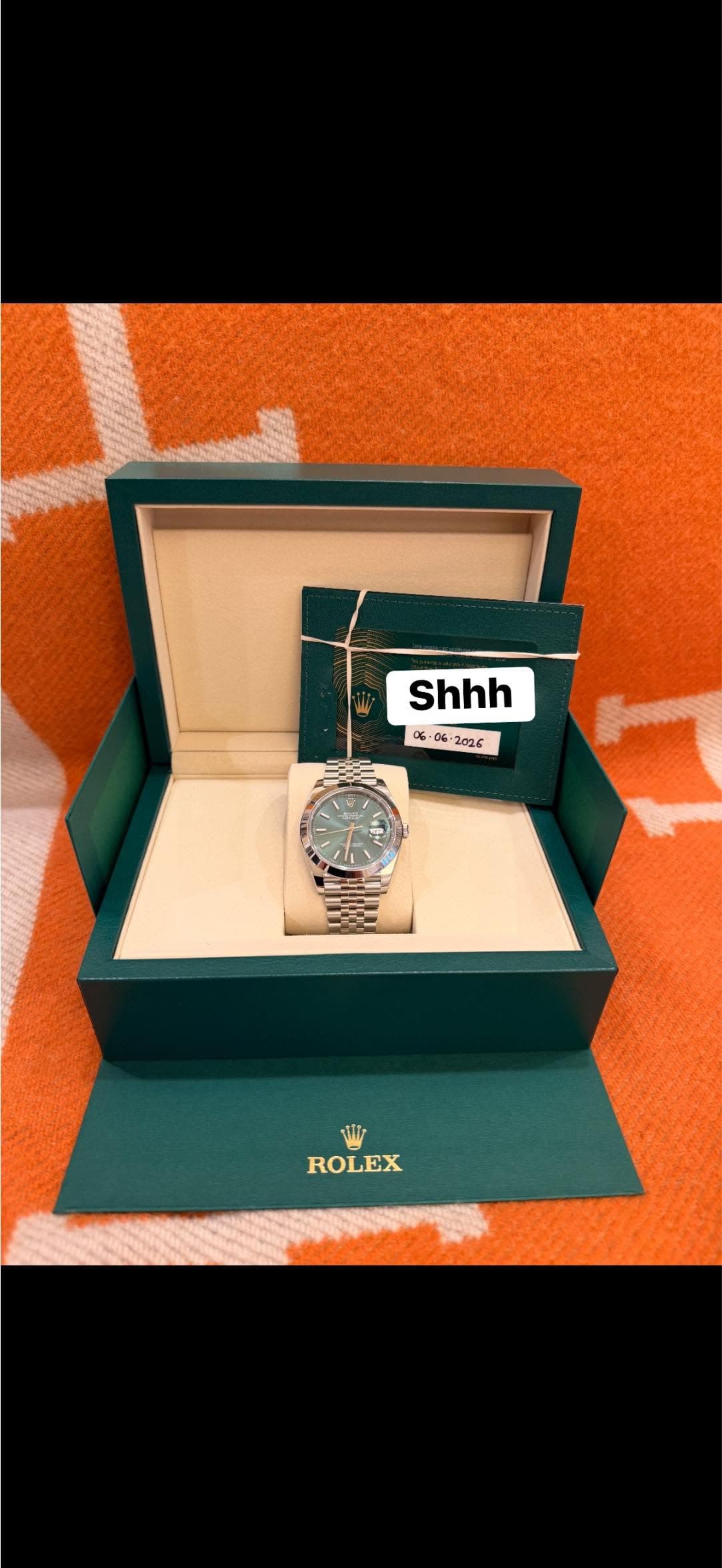 May be an image of wrist watch, fragrance and text that says 'Shhh 06 o သ ၁ 2026 間 ROLEX'