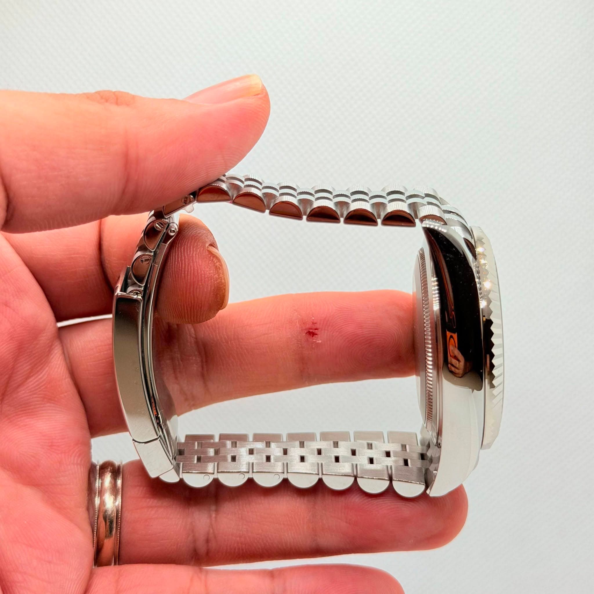 May be an image of wrist watch and jewelry